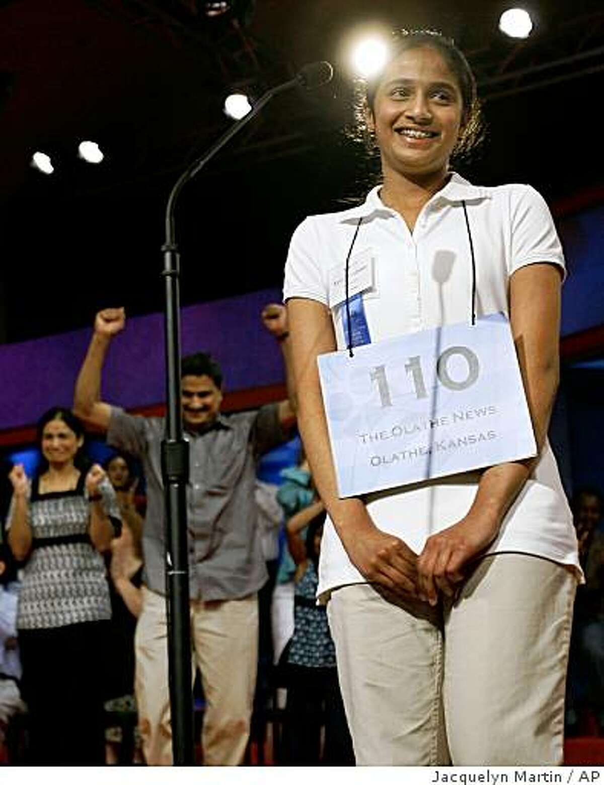 Kavya Shivashankar, 13, of Olathe, Kansas, wins the finals of the Scripps National Spelling Bee, in Washington, on Thursday, May 28, 2009. In the background her parents, Sandy Shivashankar, left, and Mirle Shivashankar celebrate. (AP Photo/Jacquelyn Martin)