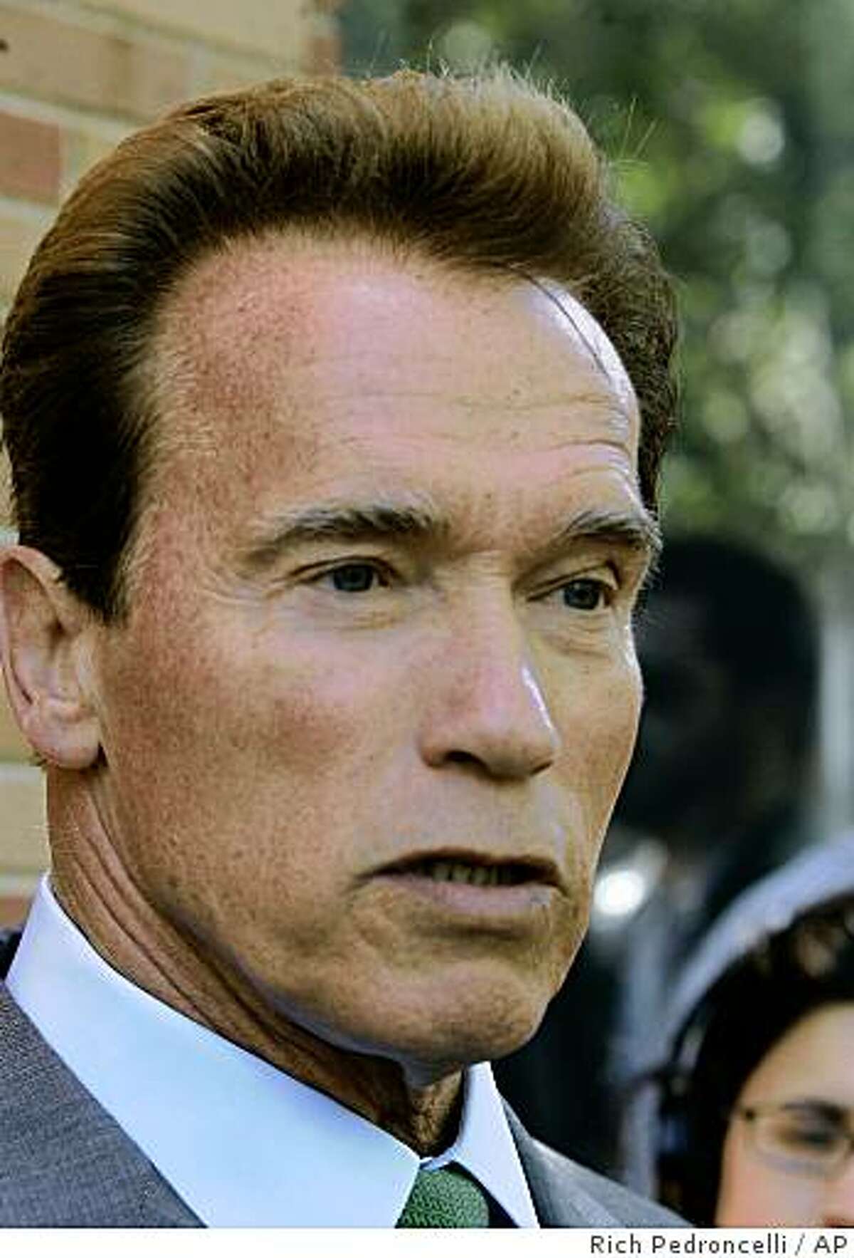 Gov. Arnold Schwarzengger tells reporters that he and lawmakers will try to quickly solve the state's $21.3 billion budget deficit without taxes, gimmicks or much borrowing, after appearing at a prayer breakfast in Sacramento, Calif., Thursday, May 21, 2009. (AP Photo/Rich Pedroncelli)