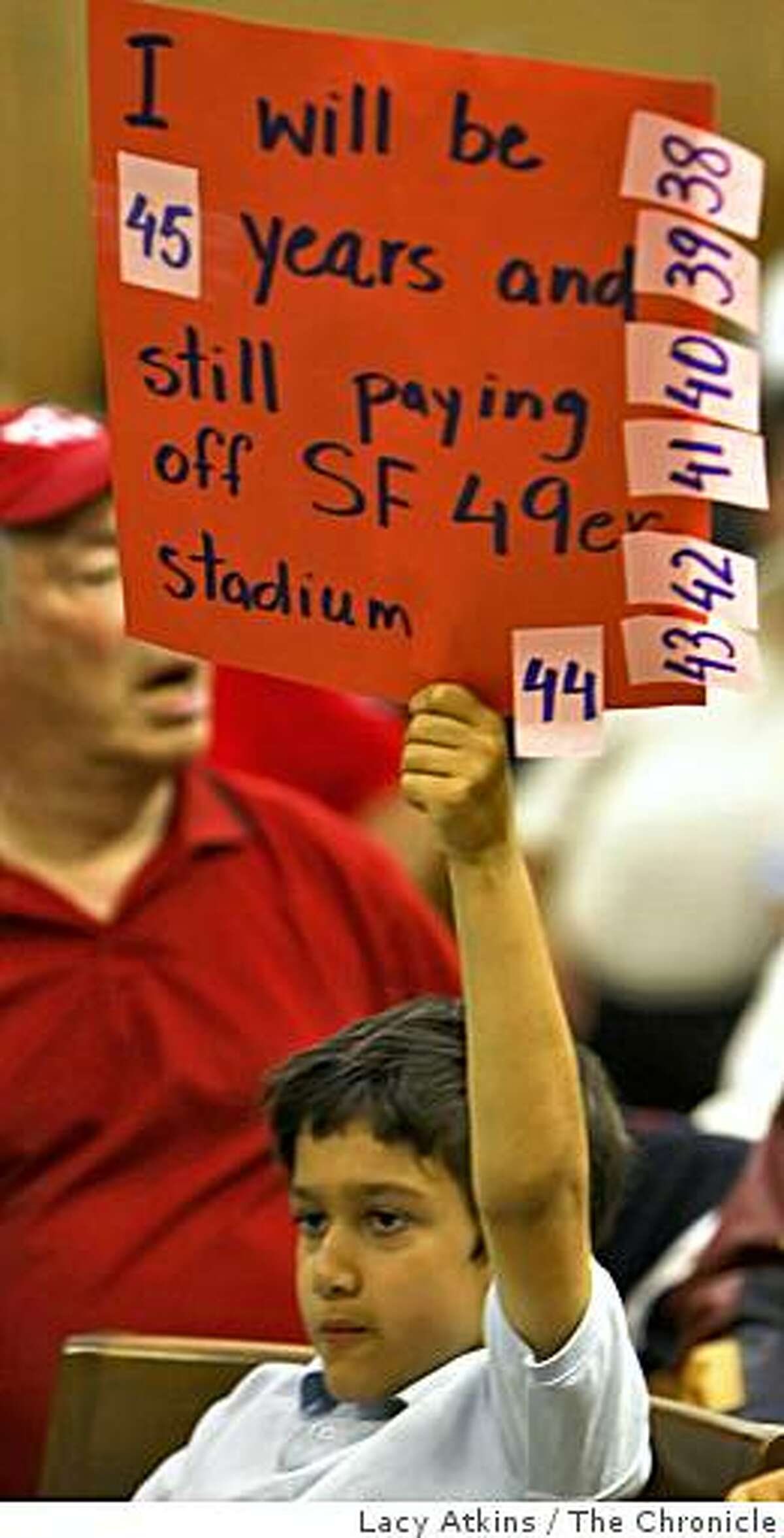 Jaafer Saadat holds up a sign against moving the San Francisco 49ers to Santa Clara, at the city council meeting, Tuesday June 2, 2009, in Santa Clara, Calif.