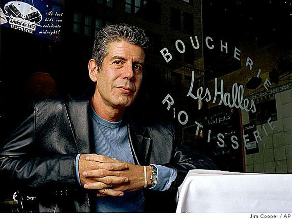 Anthony Bourdain the owner and chef of Les Halles restaurant sits at one of its tables in New York, Dec. 19, 2001.