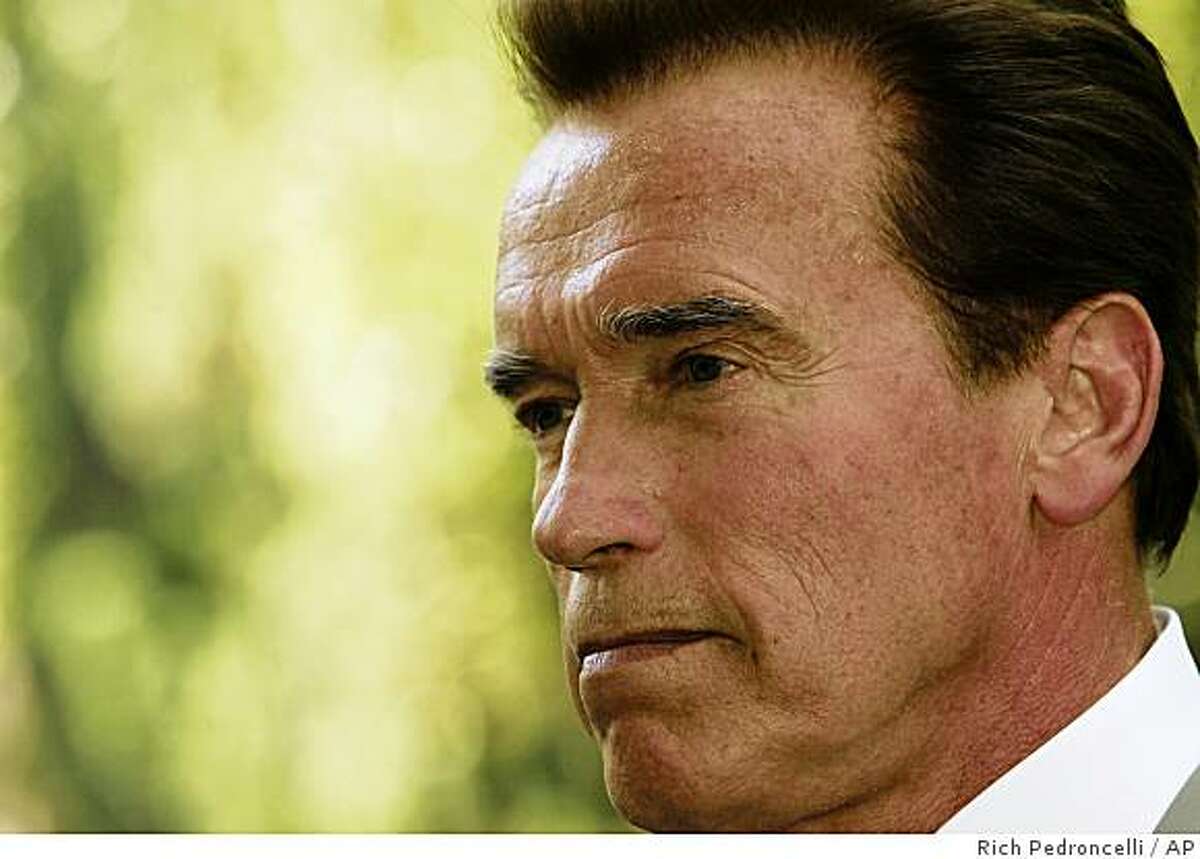 Gov. Arnold Schwarzenegger listens to a question concerning the state budget deficit while talking with reporters at the Capitol in Sacramento, Calif., Thursday, May 28, 2009. Schwarzenegger is expected to announce, Friday, that he will seek an additional five percent pay cut from state employees in an attempt to trim an expected $24.3 billion budget deficit.(AP Photo/Rich Pedroncelli)