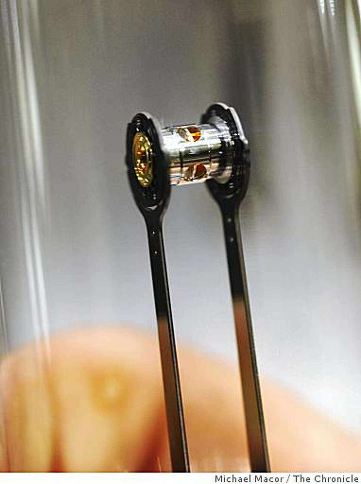 The small gold container the size of a pencil eraser is the focus of 192 laser beams, after being placed inside the target chamber. The Lawrence Livermore National Laboratory dedicates the National Ignition facility in Livermore, Calif. on Friday May 29, 2009.