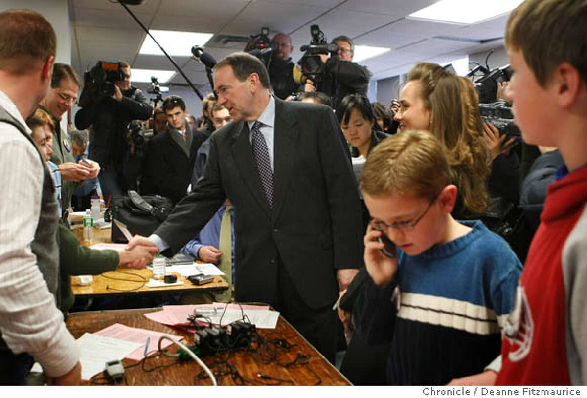 At rght, Ryan Echols, 9, (blue sweater) and Caleb Clemmons, 12, (in red) make calls to get people to support Huckabee in the caucus. The boys are with Christian Corner Stone Home Schoolers. Republican presidential candidate Mike Huckabee stops in at his campaign headquarters to meet the volunteers. Iowans will participate in the first vote of the 2008 presidential election when the Iowa caucus is held on January 3rd. Photographed in Ames on 12/31/07. Deanne Fitzmaurice / The Chronicle