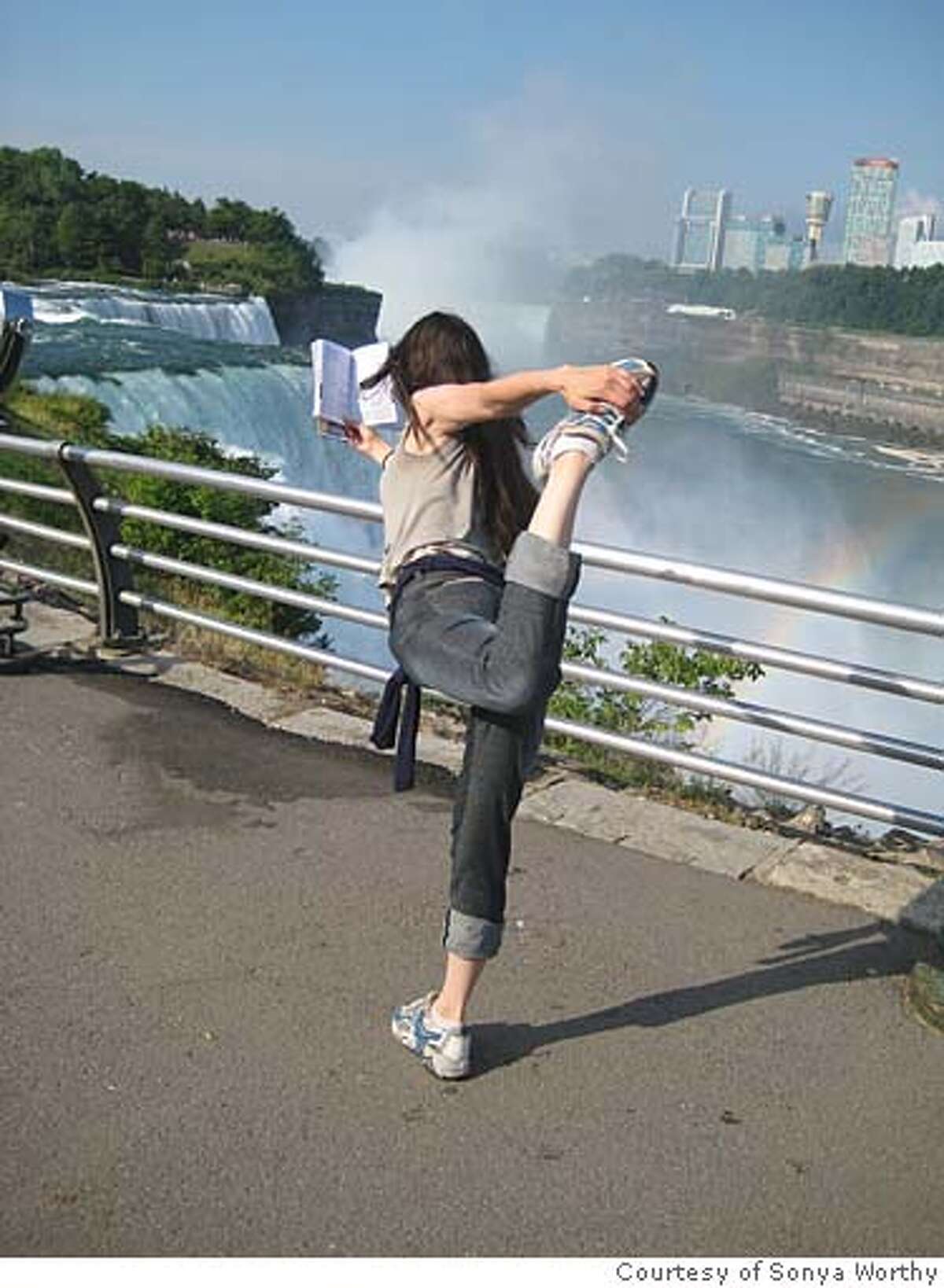 At Niagara Falls (Me) Stretching after a 23 hours of sitting on the bus and reading USA & Canada on a Shoestring, by Robert Reid, Rebecca Blond, Loretta Chilcoat, Jeremy Chipman, Tom Downs, Michael Grosberg, Jeff Hill, Graham Neale, Andrew Dan Nystrom, Michael Read, and Emily K Woman. Photo courtesy of sonya worthy