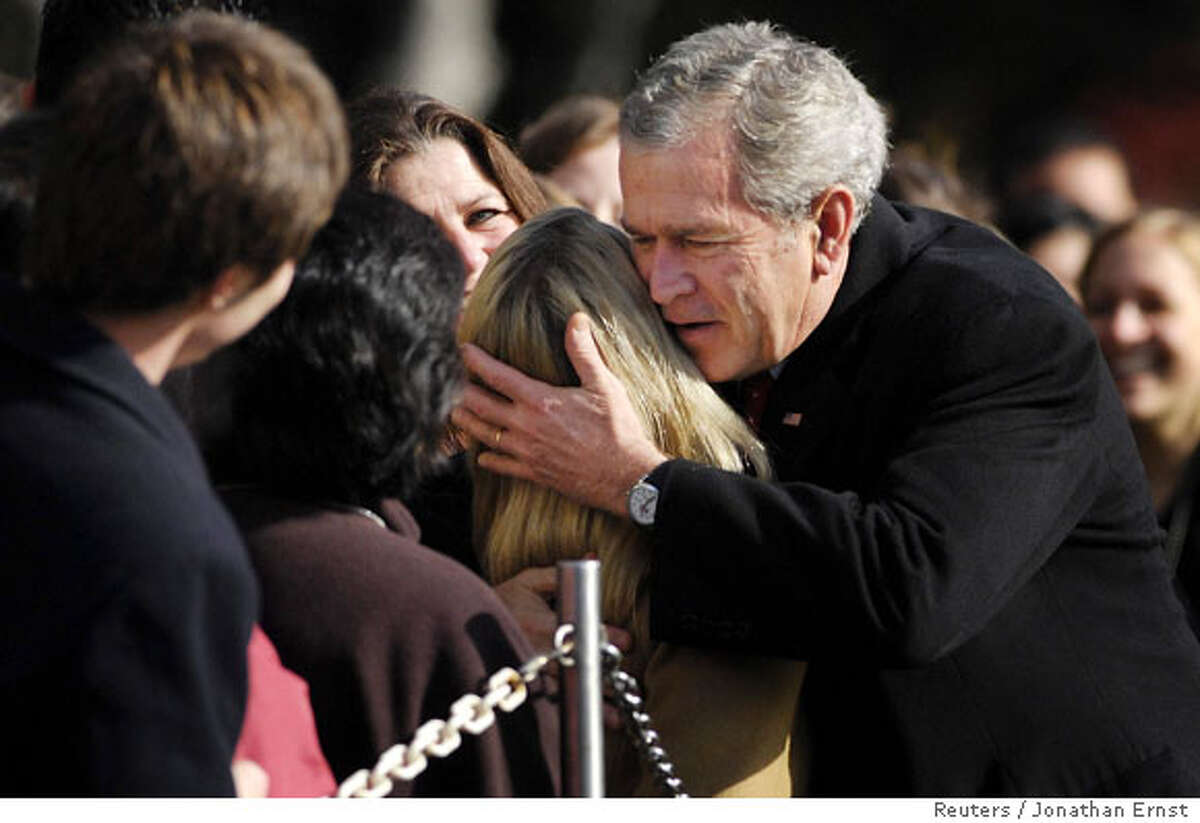 U.S. President George W. Bush gives a hug as he returns from a Thanksgiving visit at Camp David via helicopter to the White House in Washington November 24, 2007. REUTERS/Jonathan Ernst (UNITED STATES) Ran on: 11-25-2007 President Bush returns to Washington on Saturday with a hug after a Thanksgiving visit to Camp David. He and Congress are at loggerheads on funding health care for children.