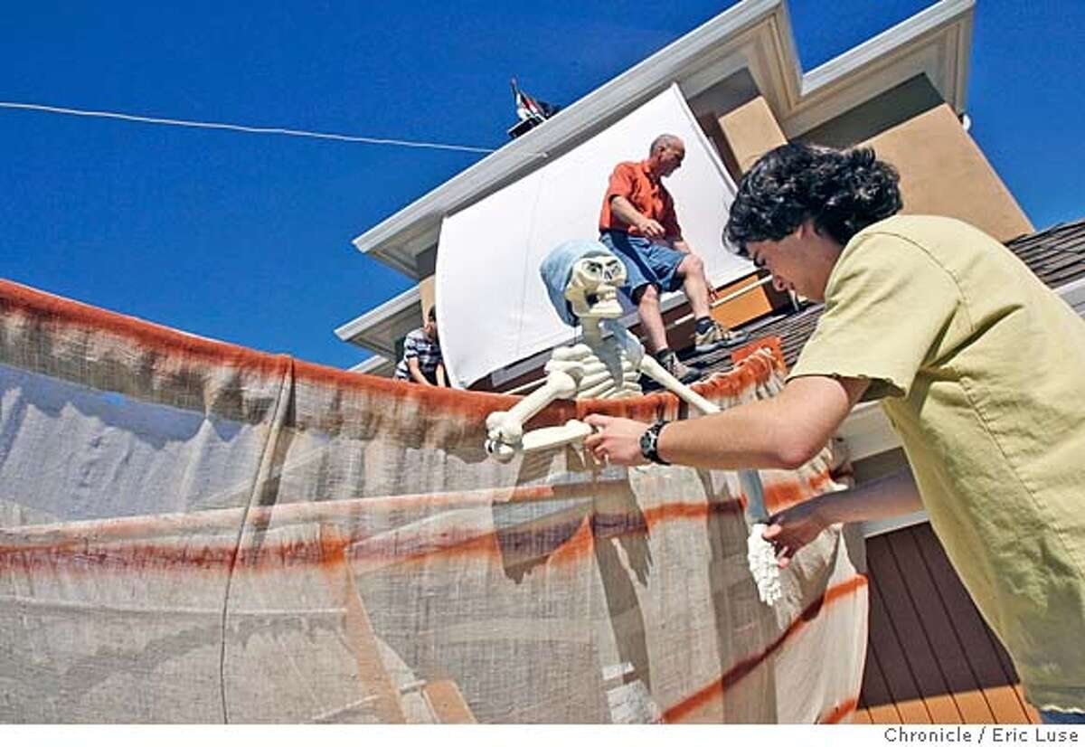 halloween_531_el.jpg Jasper attaching the pirate to the ship above the garage. On the roof is his younger brother Ethan helping his father Chris attach the sail. Jasper Anderson,16, Redwood City with his Halloween robotic display at his home. Eric Luse / The Chronicle Photo taken on 10/20/07, in Redwood CIty, CA, USA Names cq from source Jasper Anderson Ethan Chris Donna Habeeb (mom) MANDATORY CREDIT FOR PHOTOG AND SAN FRANCISCO CHRONICLE/NO SALES-MAGS OUT