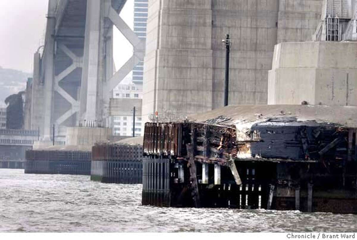 The broken up wood surrounding the number D Bay Bridge anchor is where the container ship hit the bridge. Coast Guard officials said a number of oil skimmers worked to clean up the spilled oil inside and outside the San Francisco Bay Thursday. {By Brant Ward/San Francisco Chronicle}11/8/07