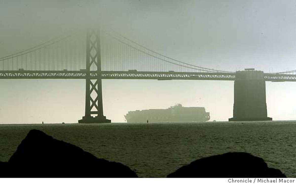 bridgehit_0137_mac.jpg The ship crosses under a fog covered Bay Bridge next to the very same tower that it struck on it's way out of the Bay. (tower on it's left). The Hanjin container ship, Cosco Busan. A large section of the shipwas damage when it came in contact a bridge tower leaving a scare on the hull about 150 feet long. Michael Macor / The Chronicle Photo taken on 11/7/07, in San Francisco, GA, USA