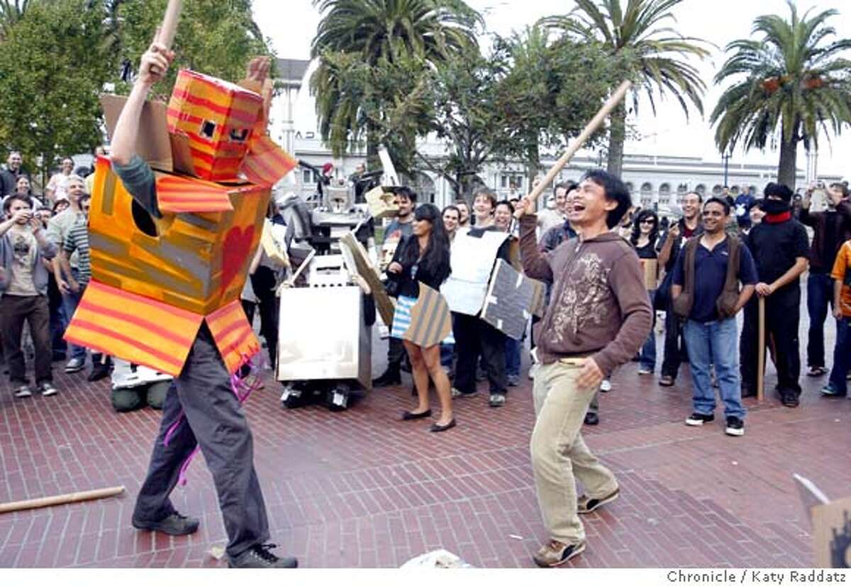 TUBEFIGHT29 L to R: Maggie Waters as a flashy orange robot battles Hung Pran at the Cardboard Tube Fighting League Tournament, held in Justin Herman Plaza, in San Francisco, CA. These pictures were made on Sunday Oct. 28, 2007, in San Francisco, CA. KATY RADDATZ/The Chronicle Photo taken on 10/28/07, in San Francisco, CA, USA