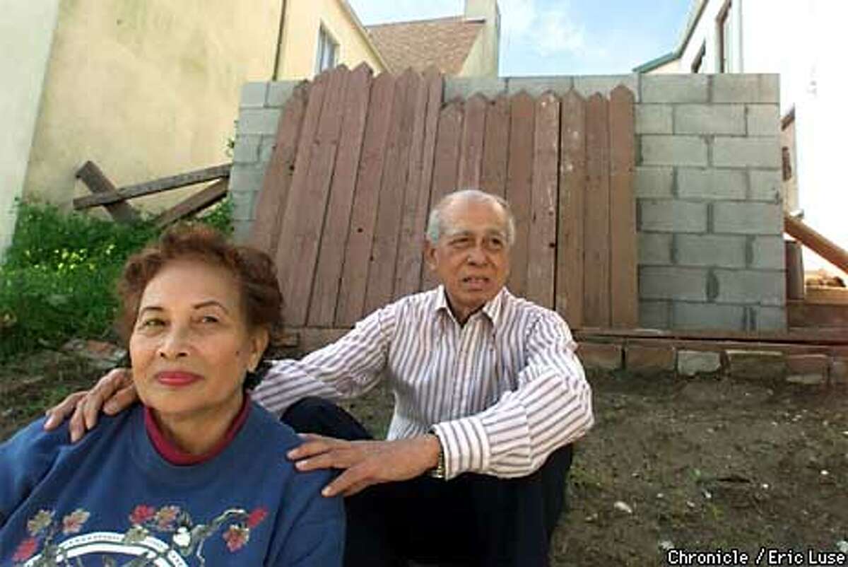 Angela and Antonio Juanillo,San Francisco, in front of the controversial wall at 5 Montecito Place. Chronicle Photo by Eric Luse
