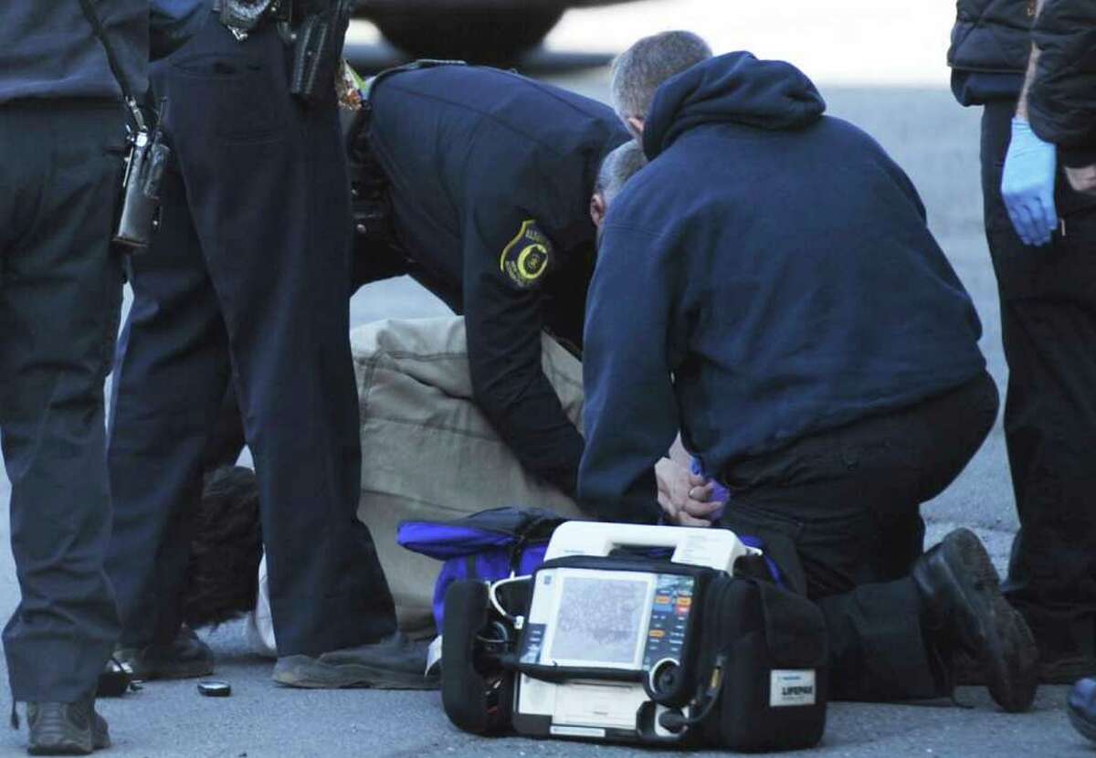 The victim of a gunshot wound is attended to by Albany Fire Department Paramedics behind the an apartment complex at 6 Brevator Street in Albany, N.Y. Feb. 10, 2012. (Skip Dickstein / Times Union)