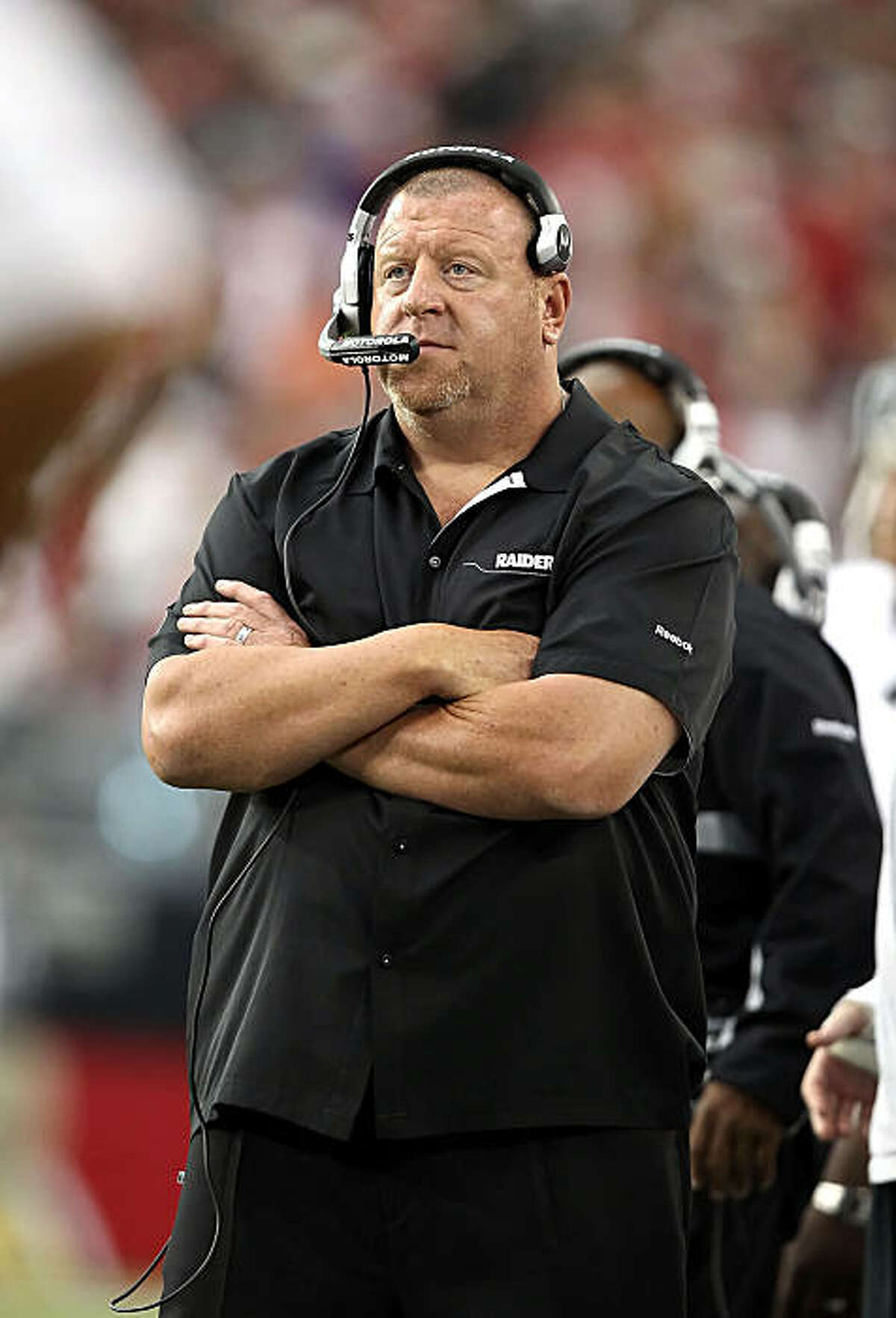 GLENDALE, AZ - SEPTEMBER 26: Head coach Tom Cable of the Oakland Raiders stands on the sidelines during the NFL game against the Arizona Cardinals at the University of Phoenix Stadium on September 26, 2010 in Glendale, Arizona. The Cardinals defeated the Raiders 24-23. (Photo by Christian Petersen/Getty Images)