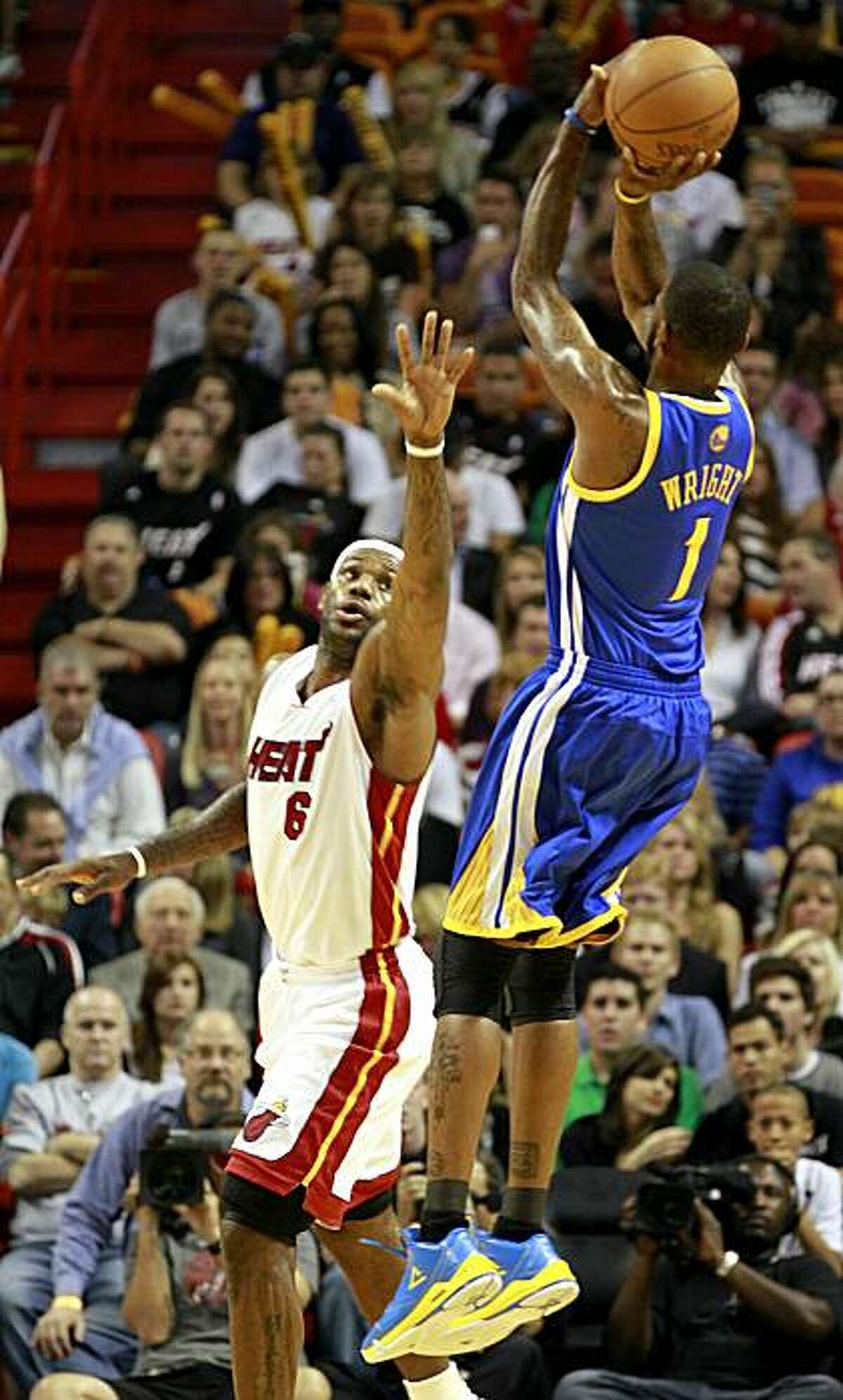MIAMI, FL - JANUARY 01: Guard Dorell Wright #1 of the Golden State Warriors is defended by froward LeBron James #6 of the Miami Heat at American Airlines Arena on January 1, 2011 in Miami, Florida. NOTE TO USER: User expressly acknowledges and agrees that, by downloading and/or using this Photograph, User is consenting to the terms and conditions of the Getty Images License Agreement.