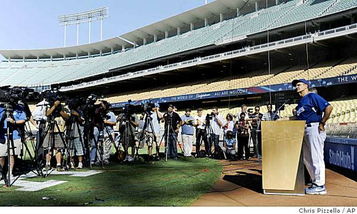 Los Angeles Dodgers manager Joe Torre, right, speaks during a news conference concerning suspended Dodgers slugger Manny Ramirez at Dodger Stadium in Los Angeles, Thursday, May 7, 2009. Ramirez was suspended for 50 games by Major League Baseball on Thursday. (AP Photo/Chris Pizzello)