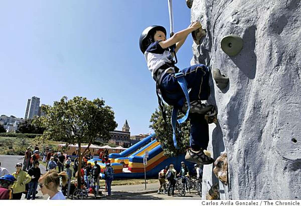 Ronin Mukai, 5, of San Francisco, tries out the climbing wall at the end of Fisherman's Wharf on Sunday, April 26, 2009, that was part of the first Sunday Streets event for 2009. The event shut down the Embarcadero from about 9 a.m. to 1 p.m. from the ballpark to Fishermans' Wharf in San Francisco, Calif.