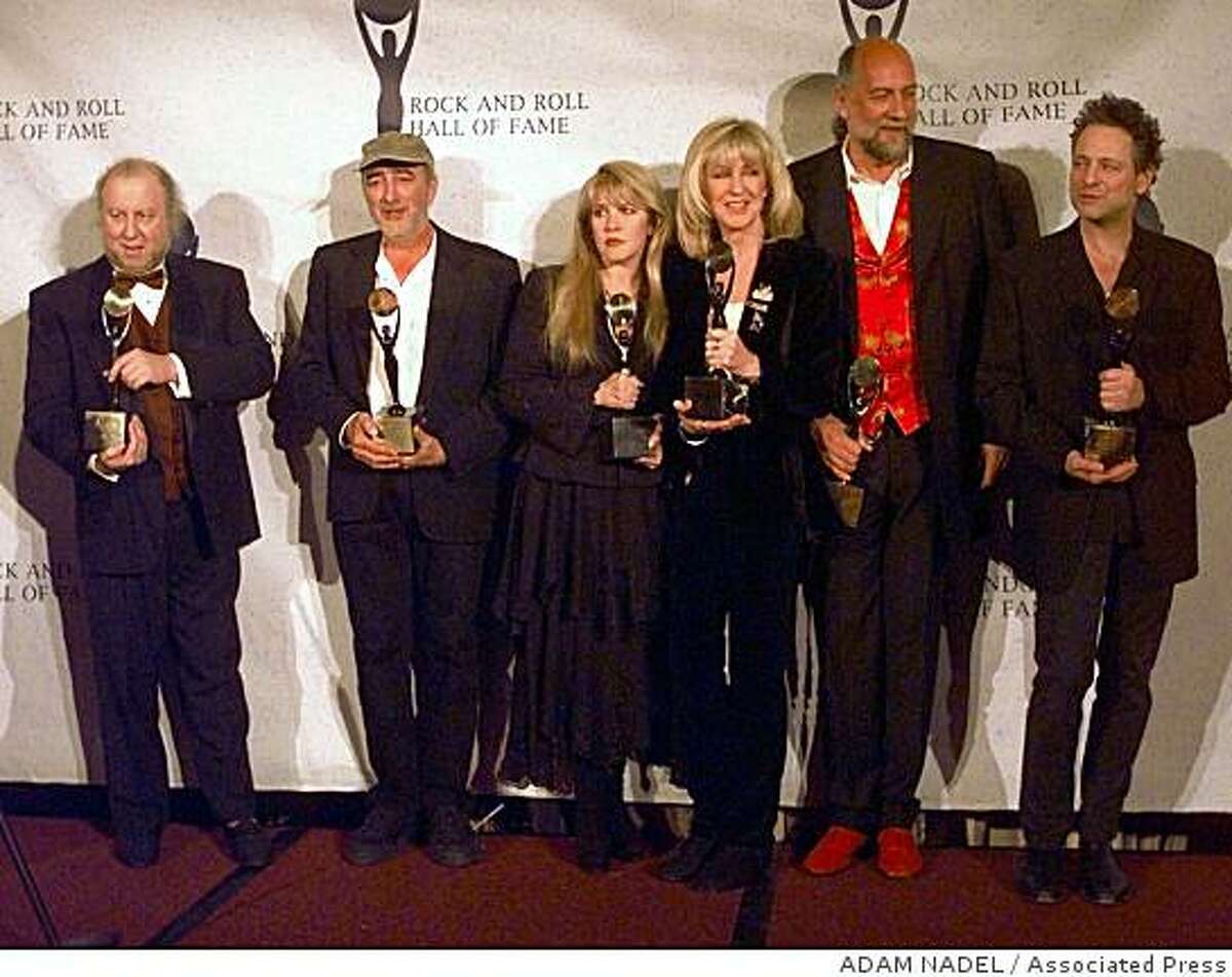 Members of Fleetwood Mac hold their awards after the group was inducted into the Rock and Roll Hall of Fame Monday, Jan. 12, 1998, in New York. From left, are: Peter Green; John McVie; Stevie Nicks; Christine McVie; Mick Fleetwood; and Lindsey Buckingham. (AP Photo/Adam Nadel)