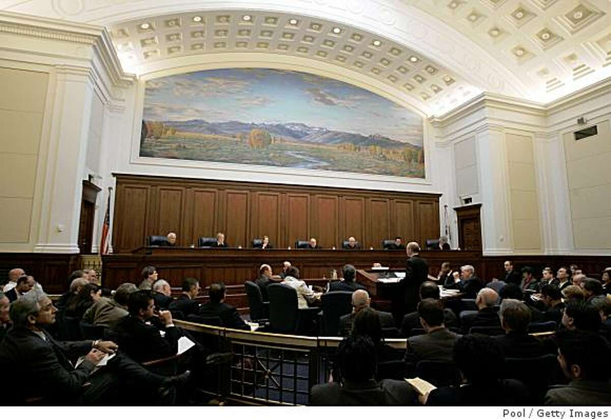 SAN FRANCISCO - MARCH 5: Shannon Minter, standing, speaks to the California Supreme Court Justices inside the California Supreme Courtroom as arguments for and against proposition 8 on March 5, 2009 in San Francisco, California. The arguments are on lawsuits seeking to overturn Proposition 8, the state's voter-approved ban on same-sex marriage. (Photo by Paul Sakuma-Pool/Getty Images)