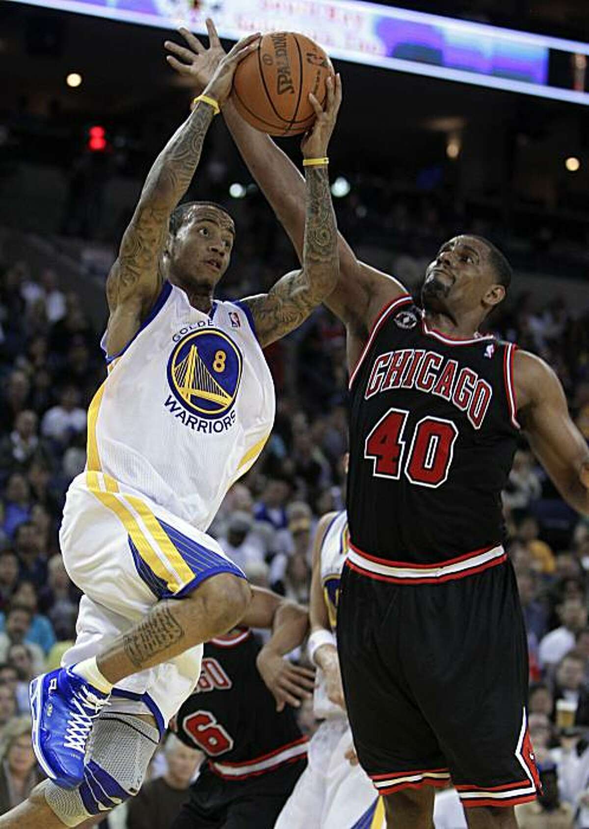 Golden State Warriors' Monta Ellis, left, goes up for a shot against Chicago Bulls' Kurt Thomas during the second half of an NBA basketball game Saturday, Feb. 5, 2011, in Oakland, Calif.
