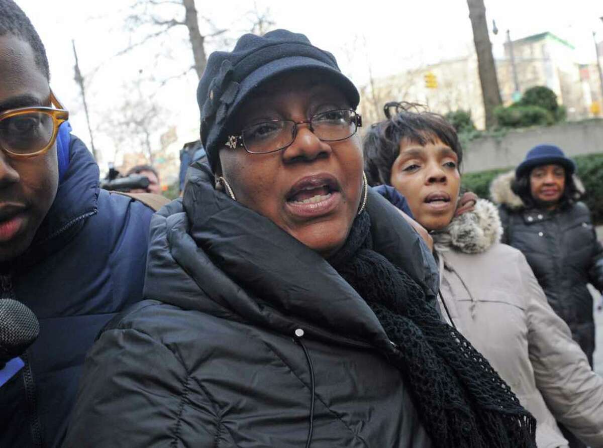 Joy White, center, whose daughter Carlina White was kidnapped as a newborn from Harlem Hospital in August 1987, exits Manhattan Federal court, Friday, Feb. 10, 2012, in New York. A prosecutor in a case against Raleigh, North Carolina, resident Ann Pettway, the woman accused of snatching the newborn, says she will plead guilty Friday to criminal charges. (AP Photo/ Louis Lanzano)