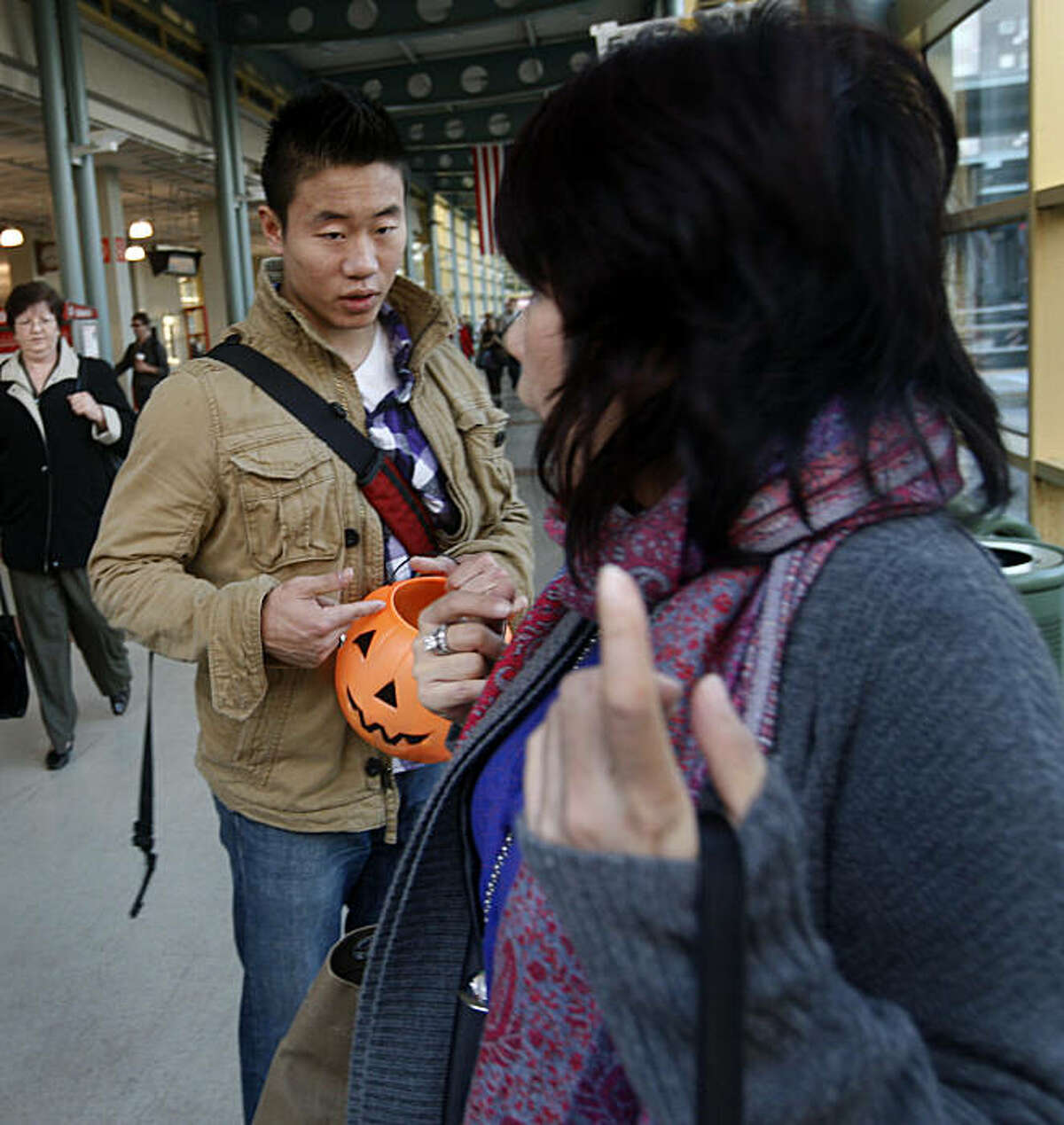 A woman (right) rejects Jason Shen's offer of free candy at the Caltrain Station in San Francisco, Calif., on Thursday, Nov. 4, 2010. Shen is taking part in a practice called Rejection Therapy, which requires participants to be rejected by someone at least once a day to get over their fear of rejection.