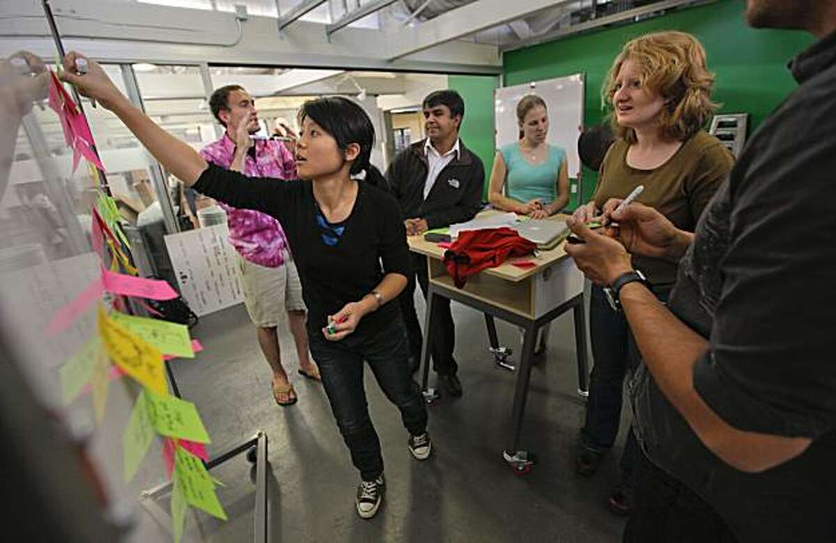 Student, Kimmy Wu attaches post it notes containing thoughts and ideas during class at the Hasso Plattner Institute for Design at Stanford University, in Palo Alto, Calif., on Friday Nov. 12, 2010.