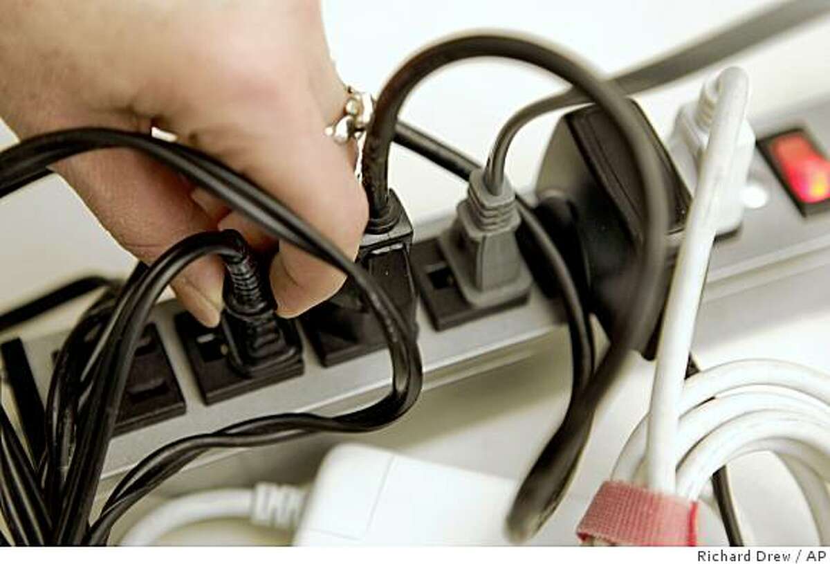 Plugs fill a power strip in this photo illustration, in New York Friday, April 10, 2009. (AP Photo/Richard Drew)
