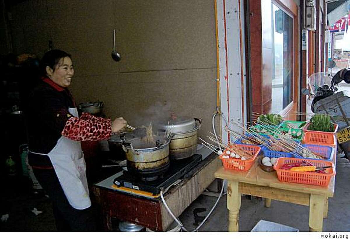 Zhang Rong borrowed money from wokai.org for her food cart in Sichuan province, China.