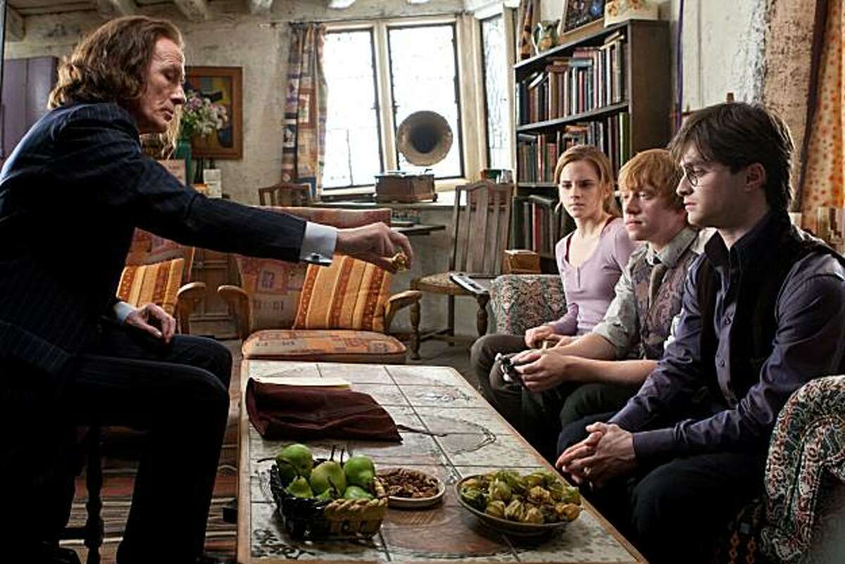 In this film publicity image released by Warner Bros. Pictures, from left, Bill Nighy, Emma Watson, Rupert Grint and Daniel Radcliffe are shown in a scene from "Harry Porter The Deathly Hallows: Part 1."