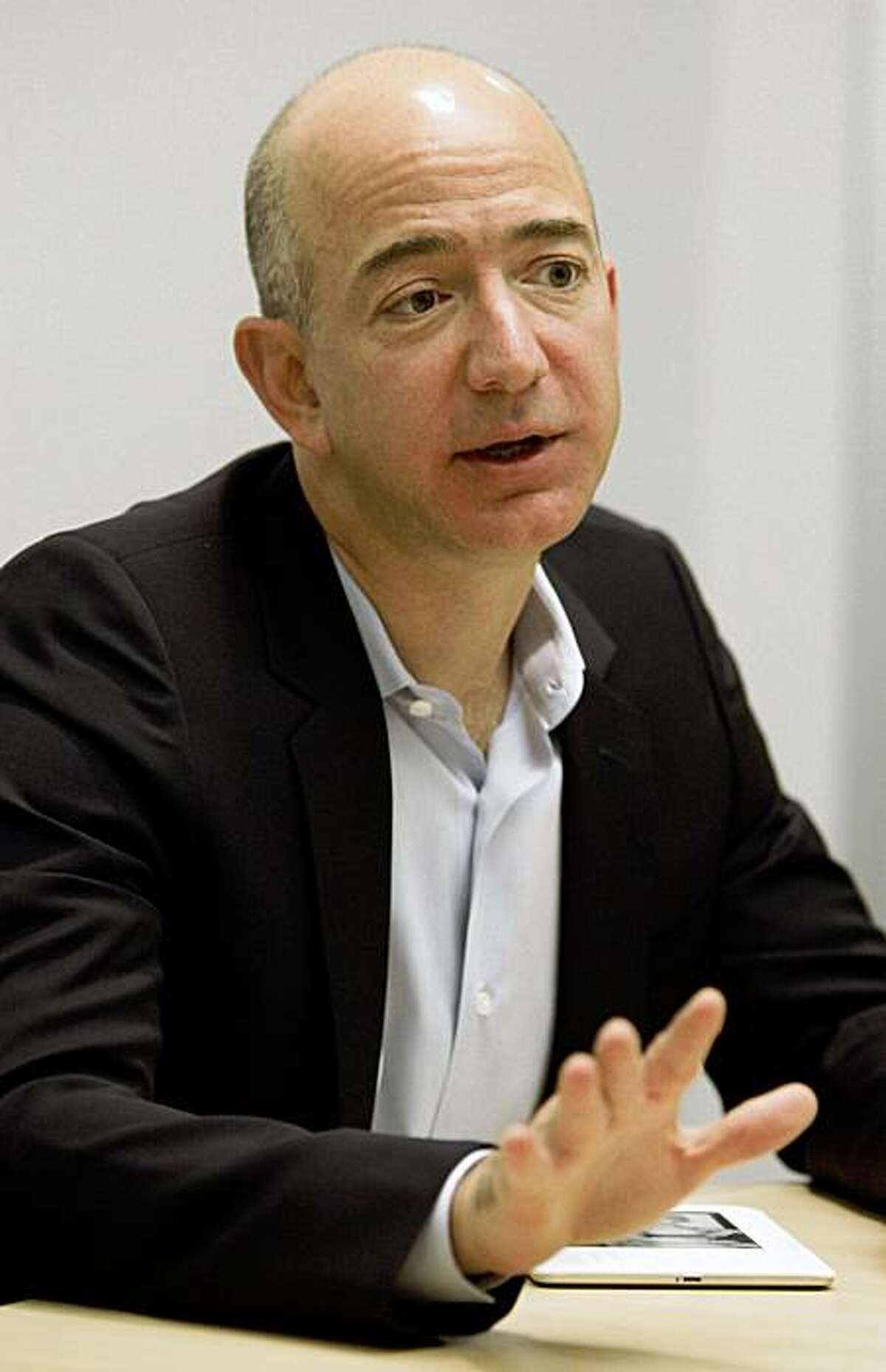 Amazon CEO Jeff Bezos gestures during an interview Tuesday, Oct. 6, 2009, in Cupertino, Calif. Amazon.com Inc. is cutting the price of its Kindle electronic-book reader yet again and launching an international version, in hopes of spurring more sales and keeping it ahead of a growing field of competitors. (AP Photo/Ben Margot)