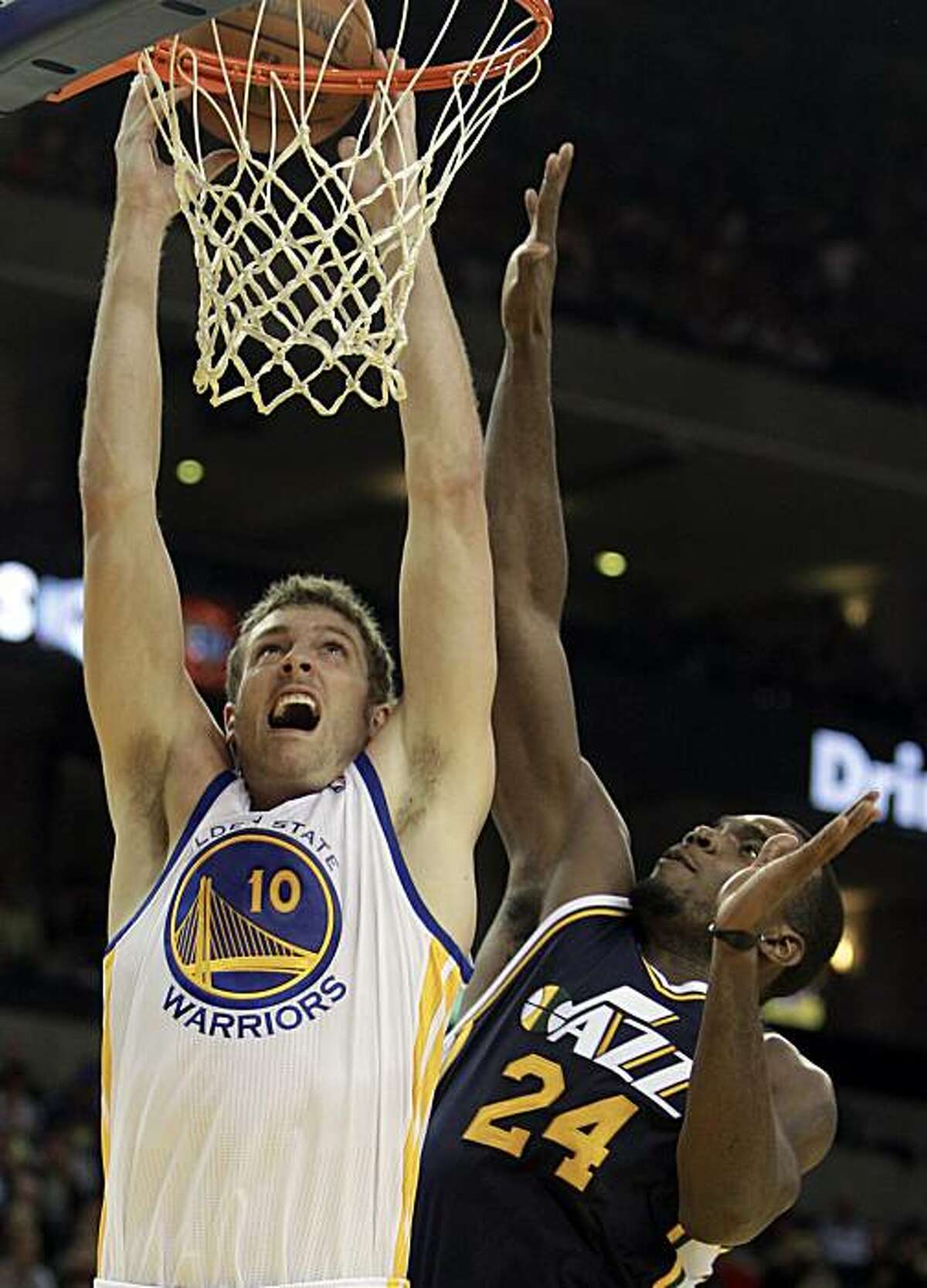 Golden State Warriors' David Lee, left, goes up for a shot over Utah Jazz forward Paul Millsap (24) during the first half of an NBA basketball game Friday, Nov. 5, 2010, in Oakland, Calif.