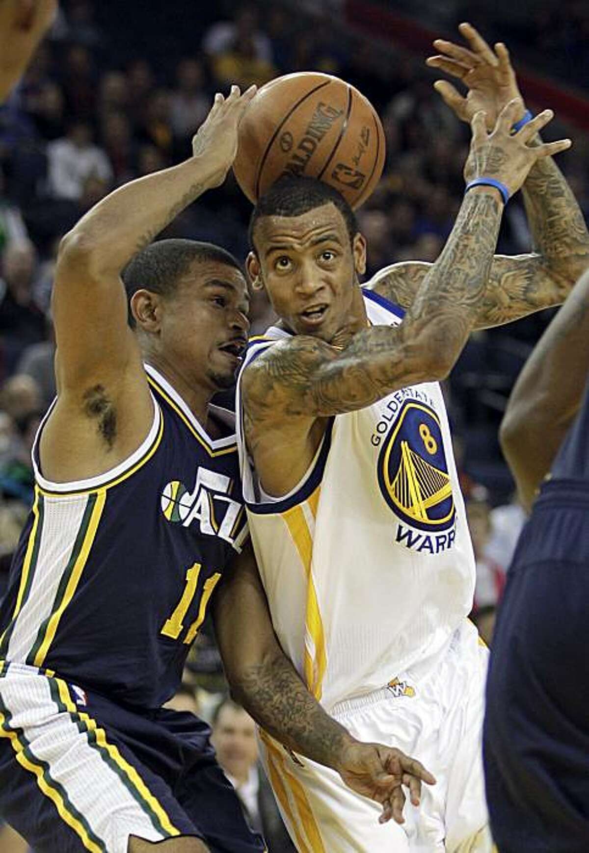 Utah Jazz guard Earl Watson, left, and Golden State Warriors' Monta Ellis fight for the ball during the first half of an NBA basketball game Friday, Nov. 5, 2010, in Oakland, Calif.
