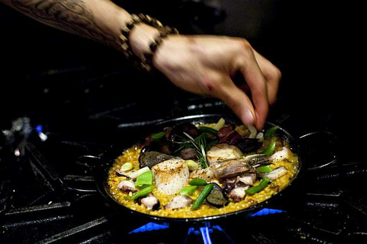 Sous-chef Jason Morales works on cooking a dish of paella at Gitane in San Francisco, Calif., on Thursday, October 28, 2010.