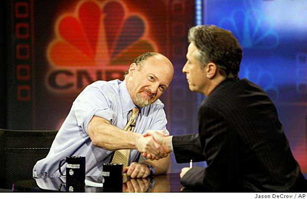 Jim Cramer, left, host of CNBC's "Mad Money" show shakes hands with Jon Stewart during an appearance on Comedy Central's "The Daily Show with Jon Stewart" Thursday, March 12, 2009 in New York. (AP Photo/Jason DeCrow)