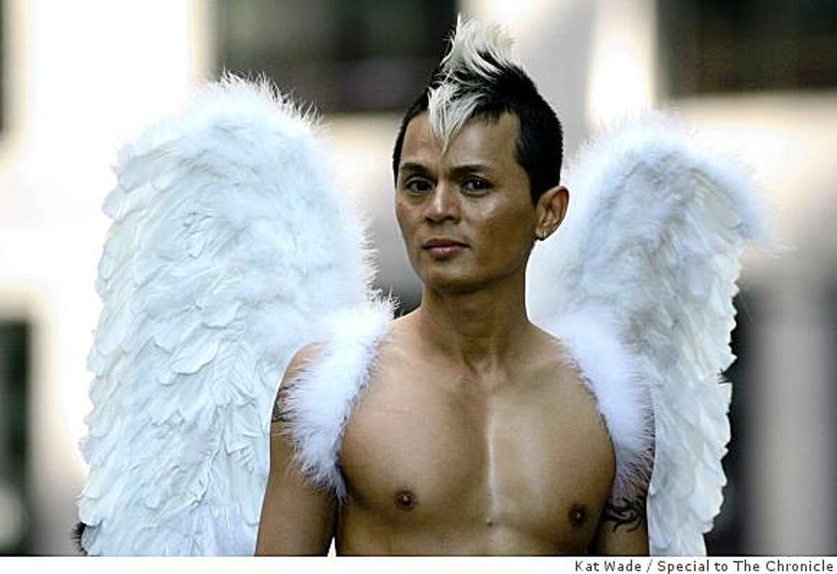Adorned with angelic wings, Leon Ho of the Vietnamese Gay Alliance strolls up Fremont Street before the Gay Pride Parade in San Francisco on Sunday.