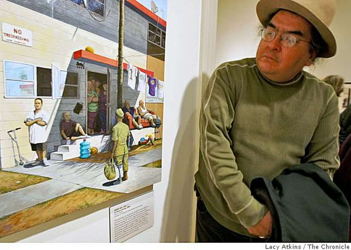 Artist Francisco Dominguez looks over the artwork of Sandow Birks', " GI Homecoming", from the new exhibit "Hobos to Street People," at the California Historical Society, Thursday Feb. 19, 2009, in San Francisco, Calif.
