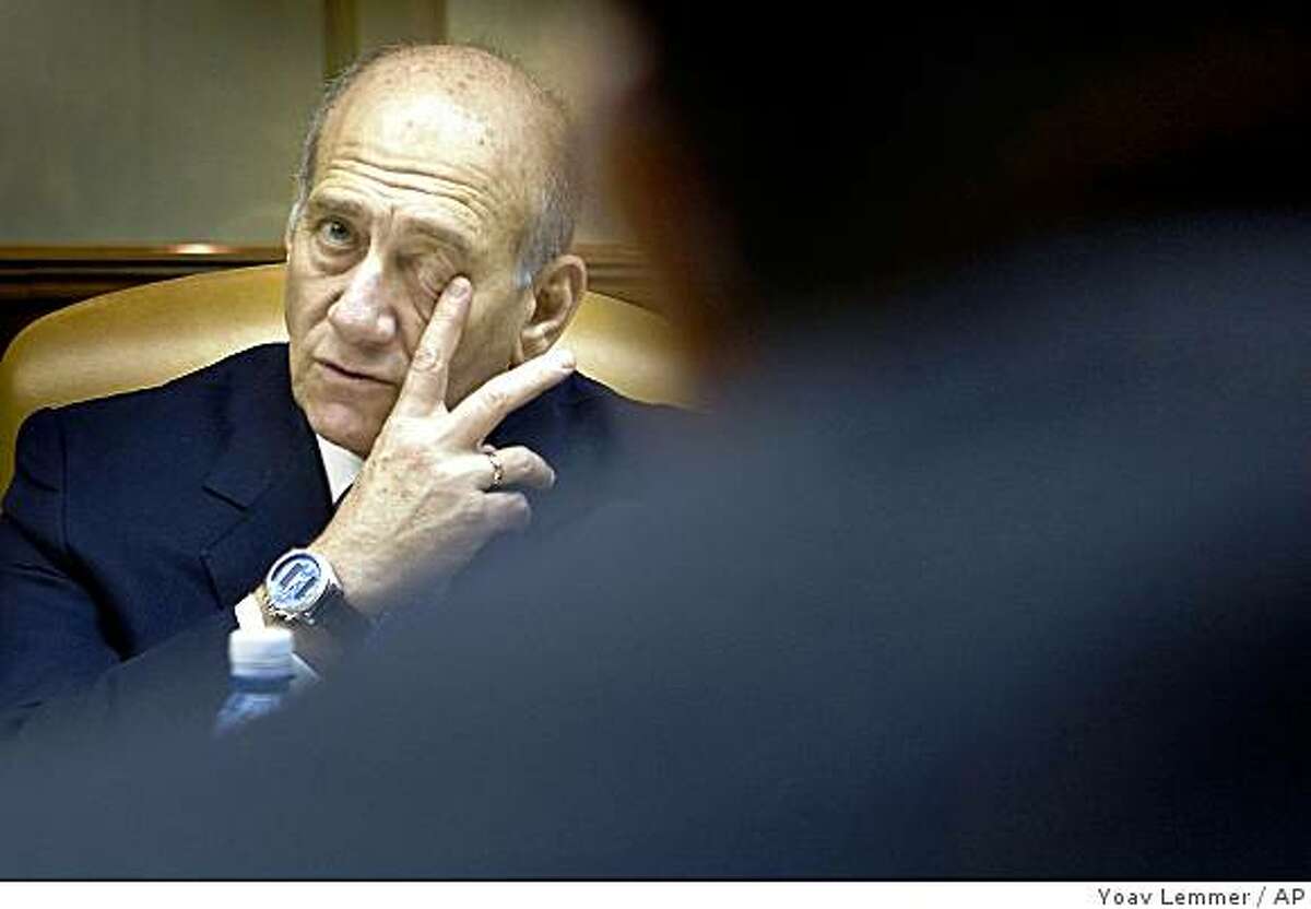 Outgoing Israeli Prime Minister Ehud Olmert attends the weekly cabinet meeting in Jerusalem, Sunday, March 1, 2009. Olmert threatened "uncompromising" retaliation against Gaza militants Sunday as the country's leadership met, six weeks after halting a military offensive meant to end Palestinian rocket fire, to decide how to respond now that it appears clear that goal was not achieved. (AP Photo/Yoav Lemmer, Pool)