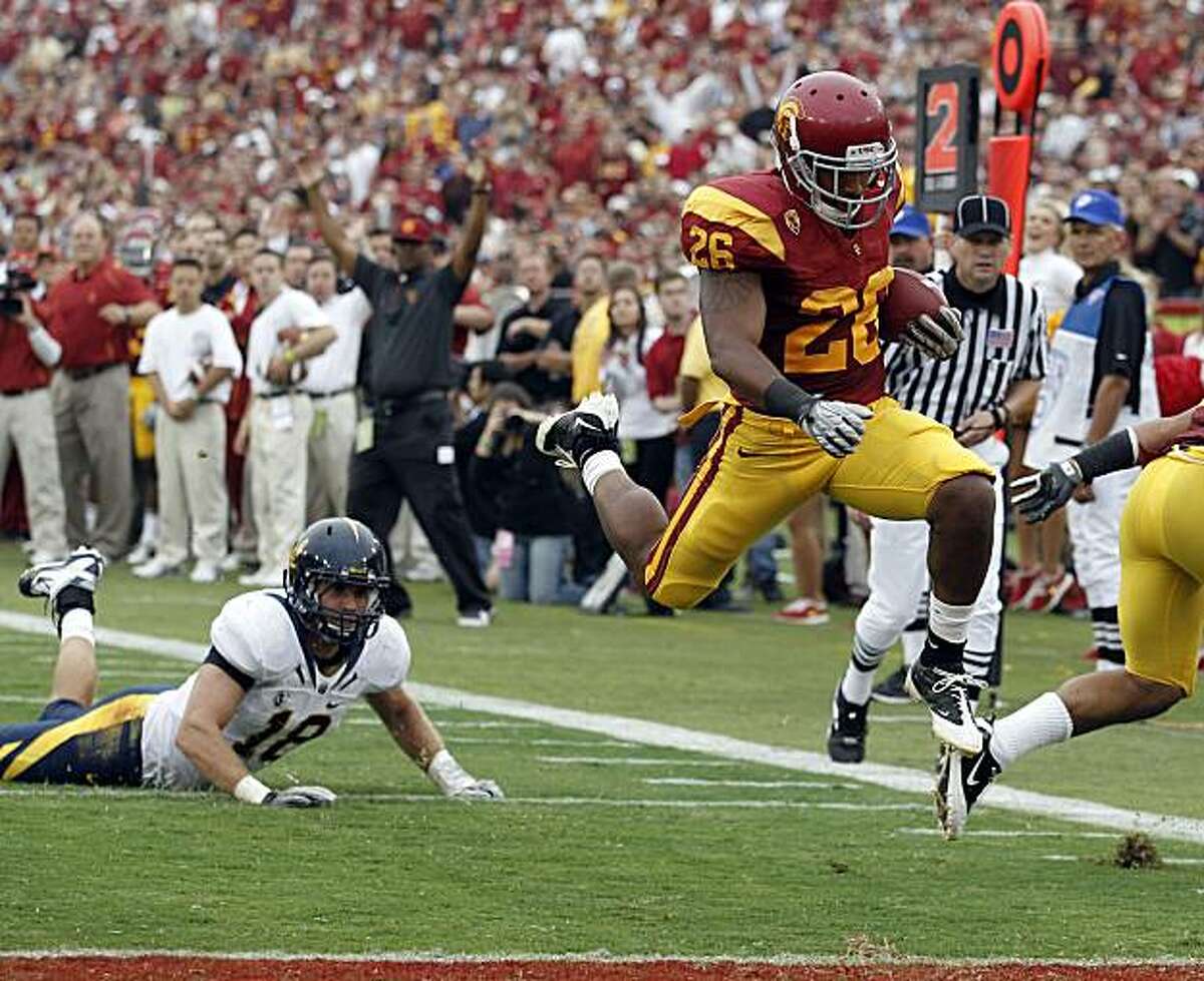Southern California running back Marc Tyler, right, scores as California linebacker Michael Mohamed looks on during the first half of an NCAA college football game in Los Angeles, Saturday, Oct. 16, 2010.