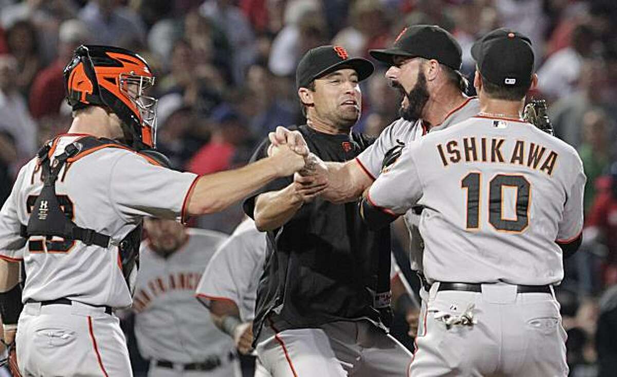 San Francisco Giants pitcher Brian Wilson, second from right, celebrates with teammates including Travis Ishikawa (10) and catcher Buster Posey, left, after a 3-2 win over the Atlanta Braves in Game 4 of baseball's National League Division Series on Monday, Oct. 11, 2010, in Atlanta.
