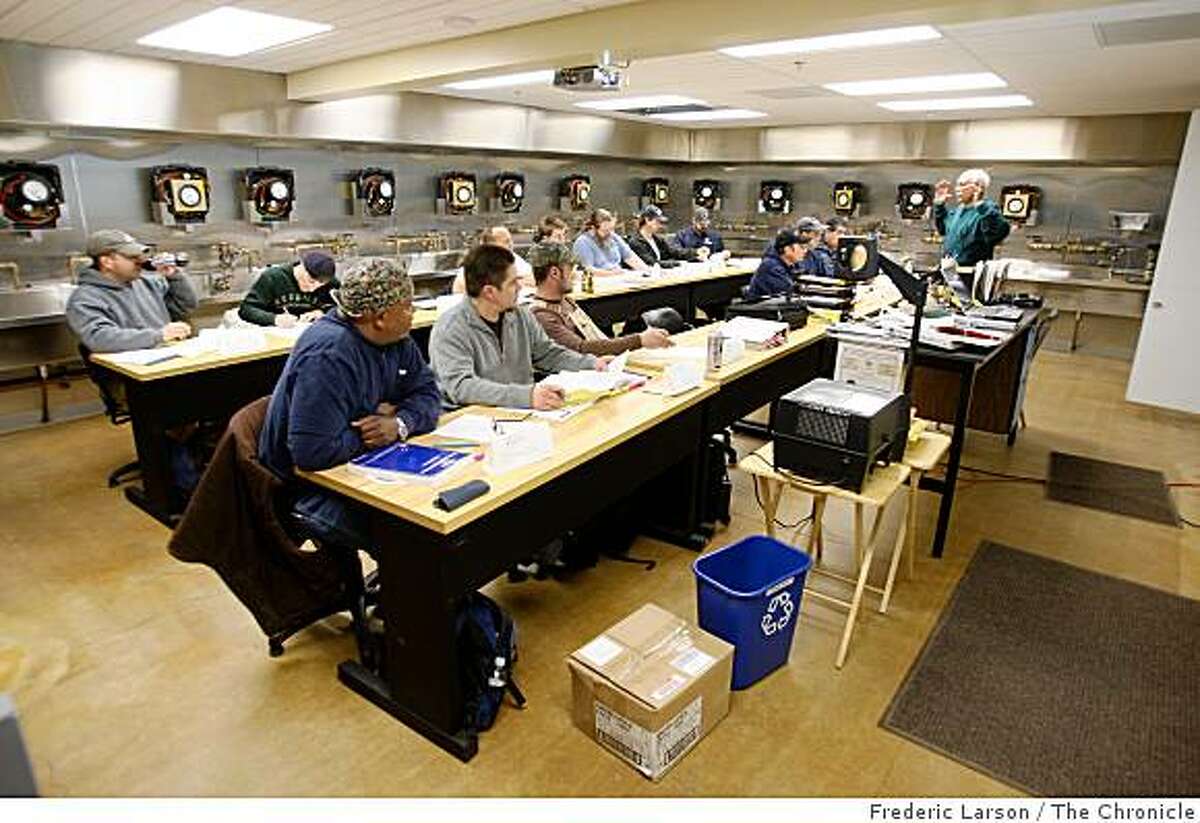 Students of plumbing sit in a night class taught by Navin Sahni at the Pipe Trades Trading Center of Santa Clara in San Jose, Calif., on February 12, 2009.