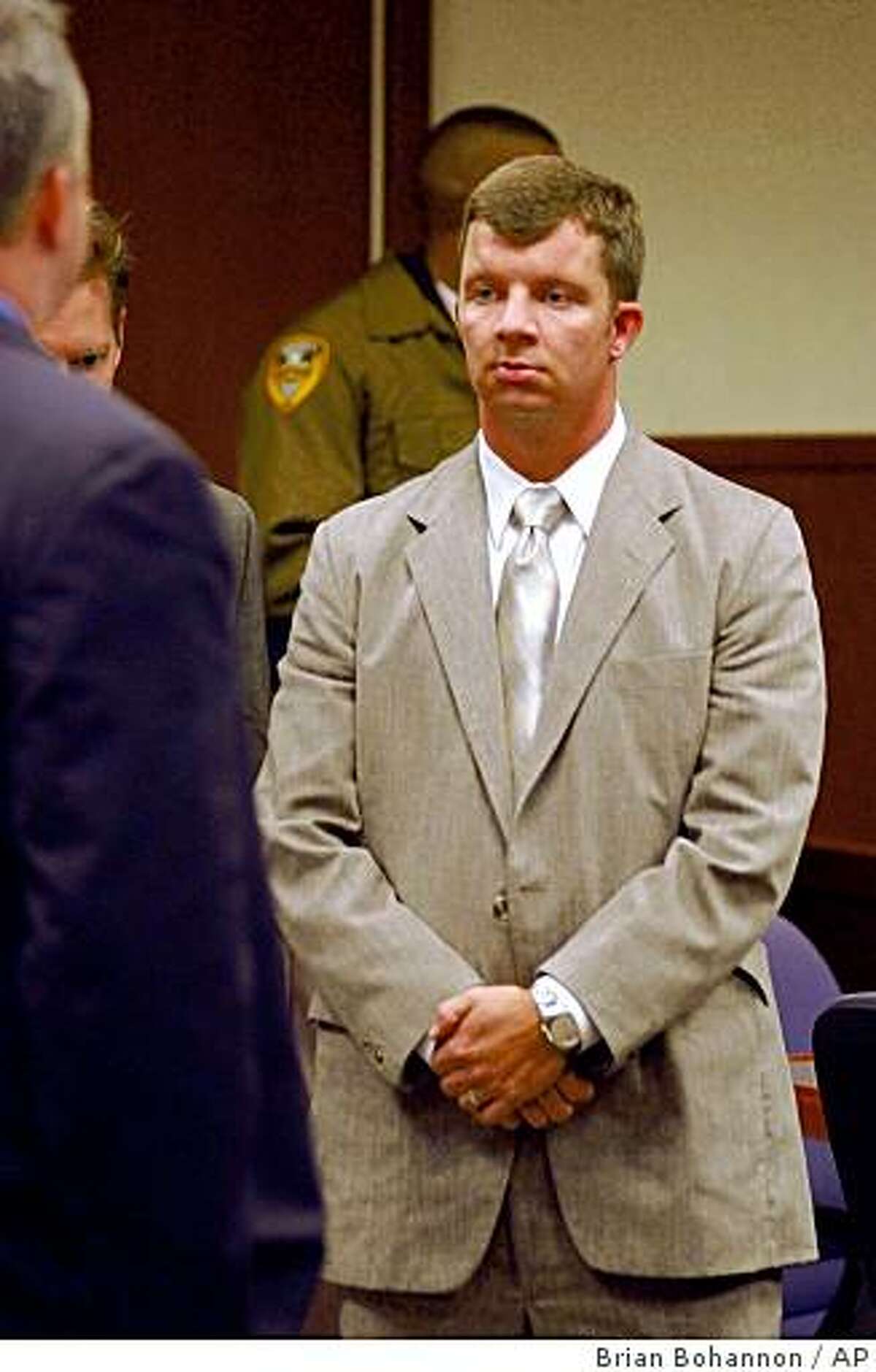 McKenzie Mattingly, a former Louisville, Ky., police detective, stands after being acquitted Wednesday, Sept. 29, 2004, of murder, manslaughter and reckless homicide in the fatal shooting in January of 19-year-old Michael Newby during an undercover drug buy. (AP Photo/Brian Bohannon)