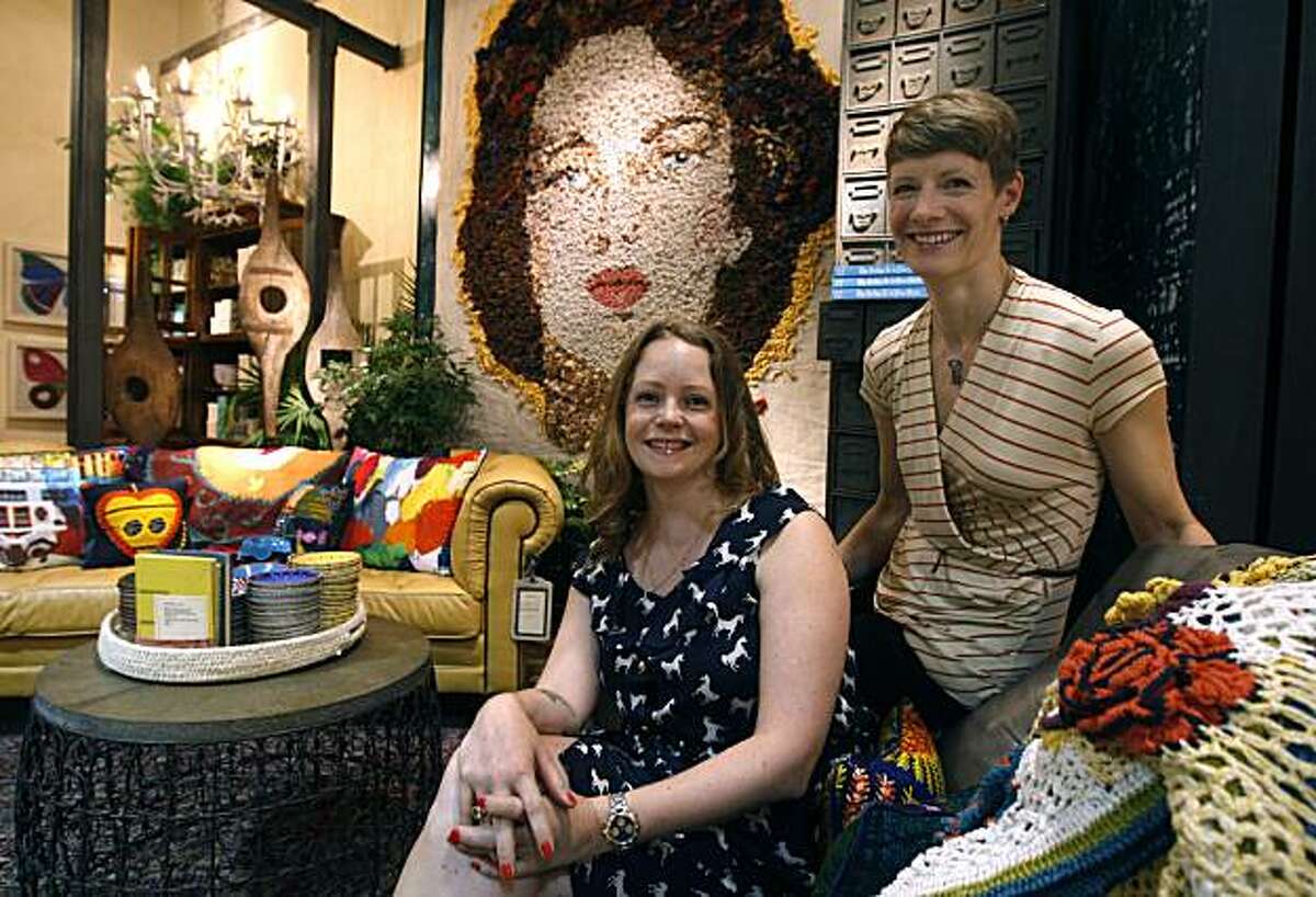 Senior visual manager Amber van Weerden (left), and Rachel Robertson, senior display coordinator, are seen in front of a large portrait, created with knotted cloth, at the Anthropologie store on Market Street in San Francisco, Calif., on Friday, July 30, 2010.