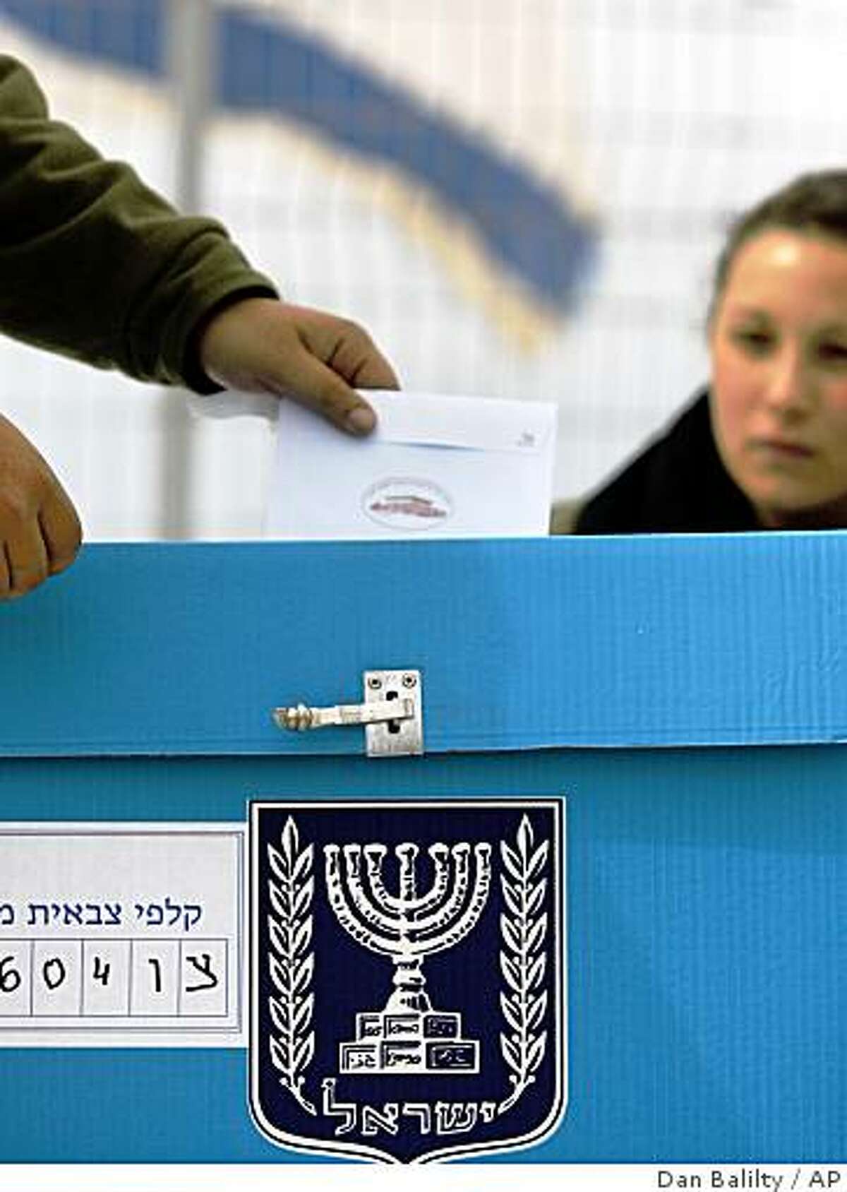 An Israeli soldier casts his ballot during an event organized by the Israeli media at a polling station at a military outpost on Mount Hermon in the Israeli controlled Golan Heights, Monday, Feb. 9, 2009. Many Israeli soldiers and police officers are voting in advance of Tuesday's polls. General elections in Israel are scheduled for Feb. 10, 2009, and pre-election polls appear to show Netanyahu with a lead over Foreign Minister and Kadima Party leader Tzipi Livni.(AP Photo/Dan Balilty)