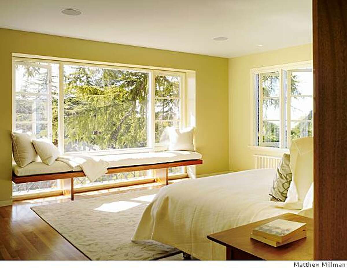 Neal Schwartz and his team of four designers gutted the rooms of this Oakland home to form a single big space in which a new floor-to-ceiling 11 by 8.6-foot rectangular mahogany box acts as a room divider.Light streams into the bedroom around each side of a mahogany box that also doubles as a dramatic backdrop for the bed and conceals a walk-in closet and powder room.