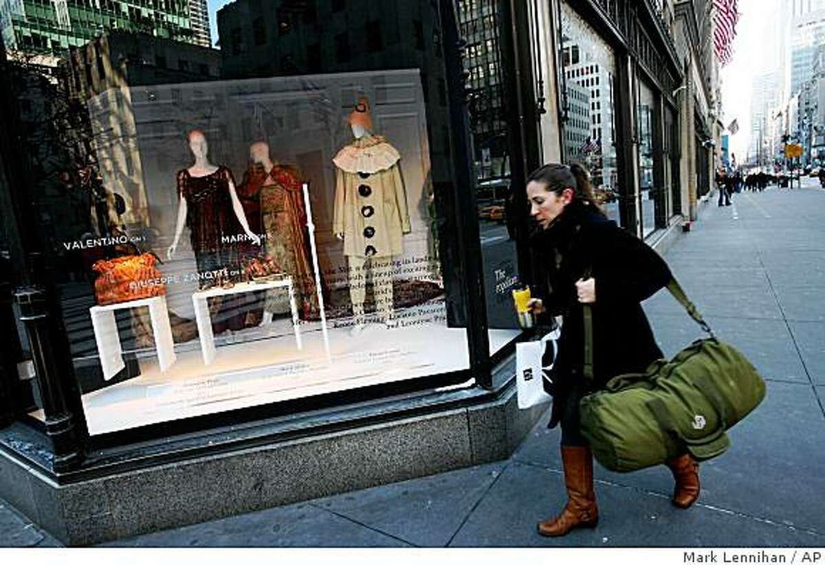 A shopper passes a window display at Saks Fifth Ave. department store Wednesday, Feb. 4, 2009 in New York. Shoppers grappling with rising layoffs and shrinking retirement accounts dug deep into survival mode last month, leading to sharp January sales declines for many retailers. Luxury stores fared the worst as well-heeled shoppers have been shell-shocked by the massive layoffs on Wall Street and their fast-eroding stock portfolios. (AP Photo/Mark Lennihan)