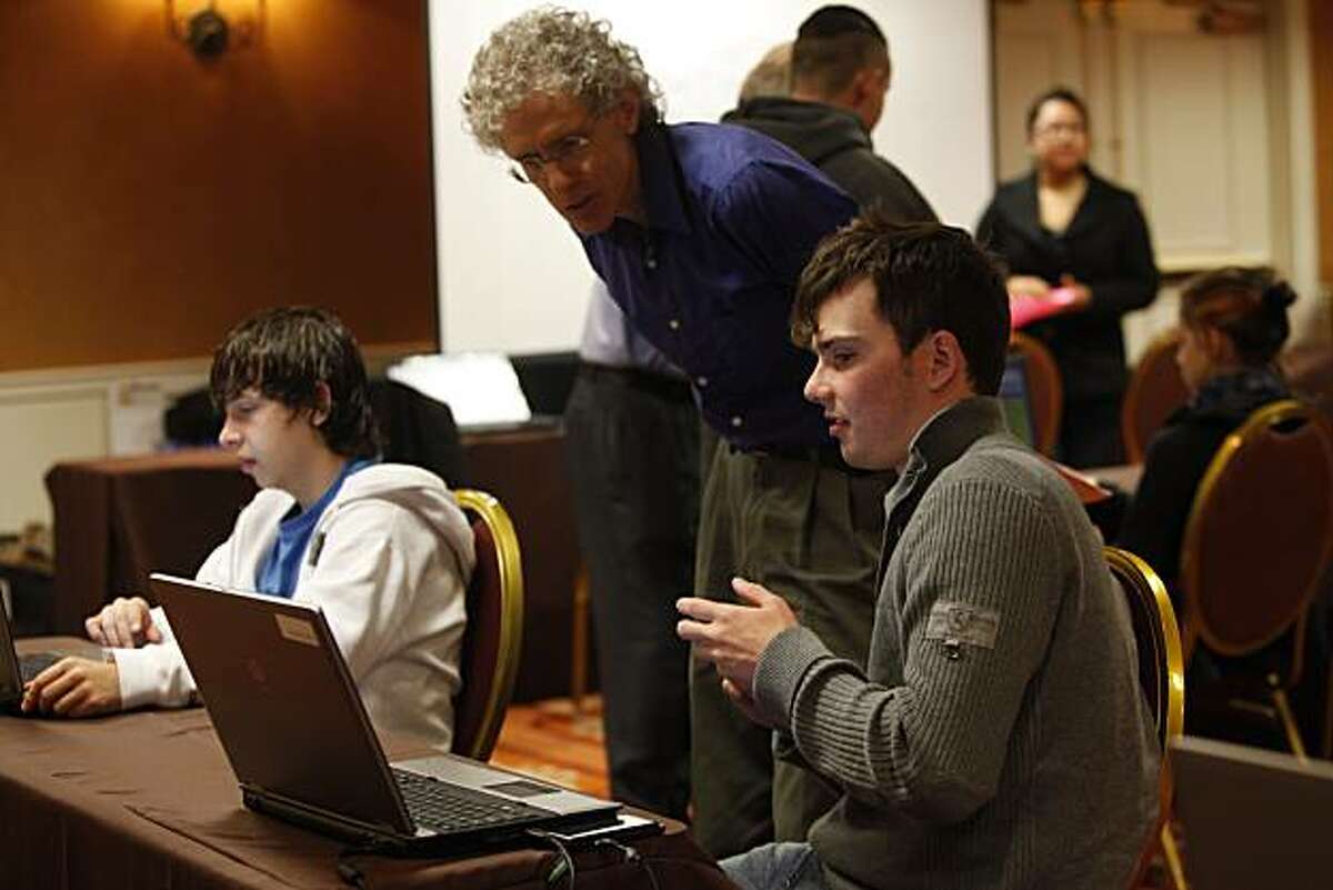 John Bradford (right), 15, discusses an Algebra assignment with Dan Kirshner (second from right), math and science teacher, while doing schoolwork in the Vienna Room at the Hotel Monaco, the San Francisco Flex Academy temporary site in San Francisco, Calif. on Thursday September 16, 2010.