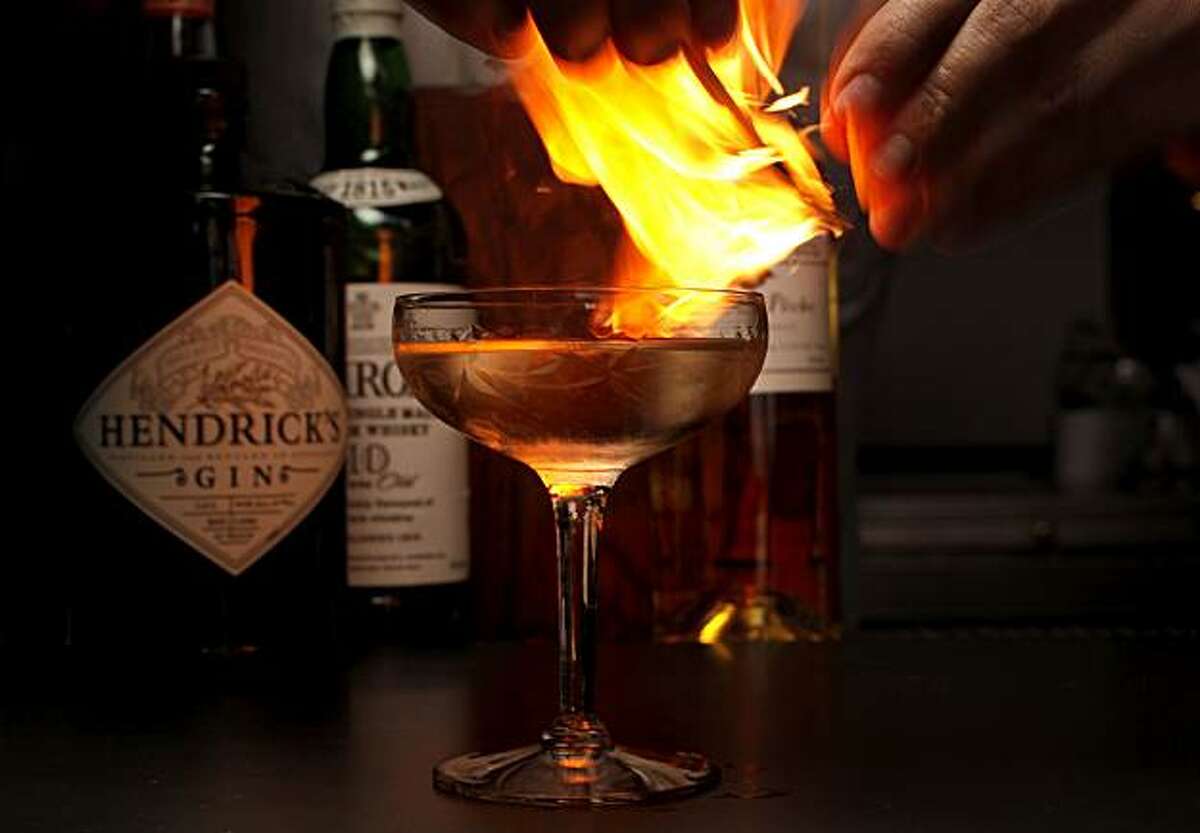 Bar manager Morgan Schick adds a flaming orange rind to finish his specialty drink, a "Gentleman Caller" at the Thermidor restaurant, in San Francisco, Calif., on Thursday August 26, 2010.