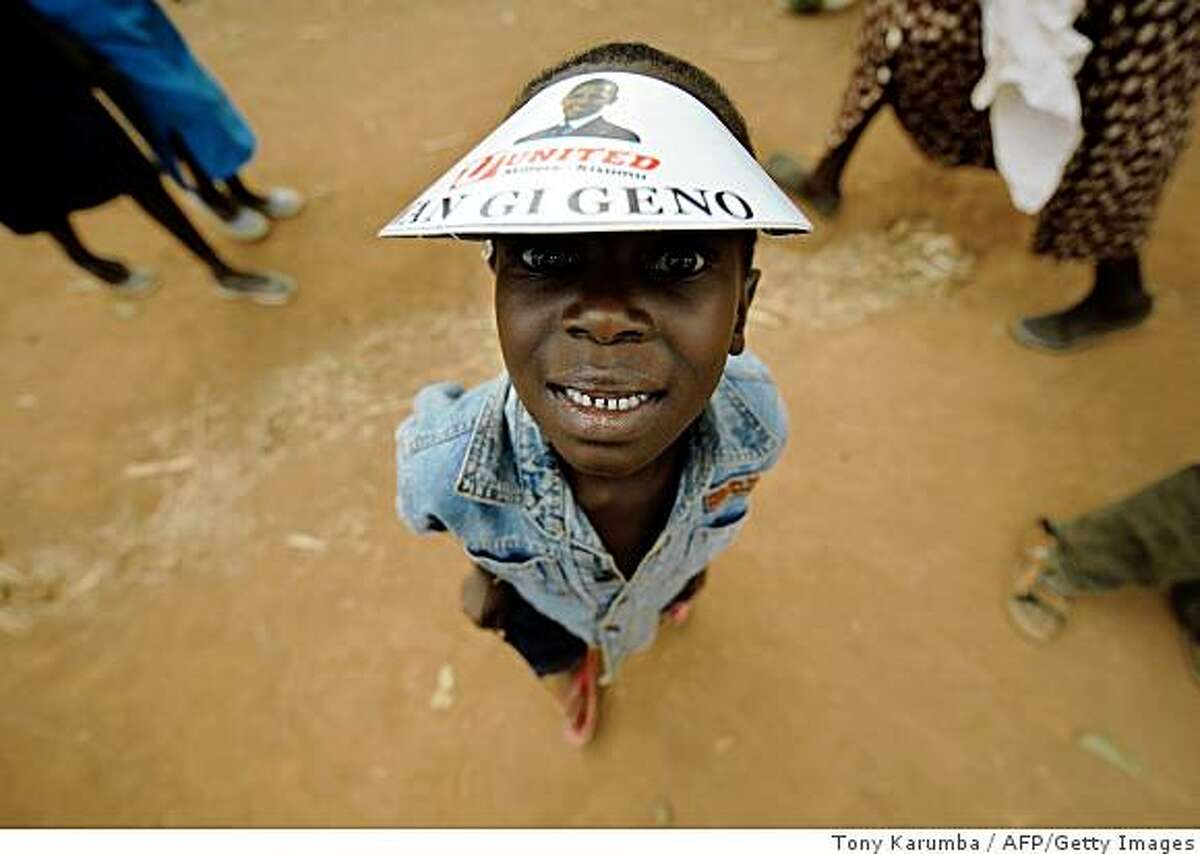 A villagers of Nyang'oma wears a paper hat with a message reading 'We have Hope' ahead of the inauguration of US President-elect Barack Obama on January 20, 2009 in Kogelo. More than 2,000 Kenyans and tourists united in song and dance to celebrate Barack Obama's inauguration in Kogelo, the Kenyan village where the new US president's father was born. AFP PHOTO/ Tony KARUMBA (Photo credit should read TONY KARUMBA/AFP/Getty Images)