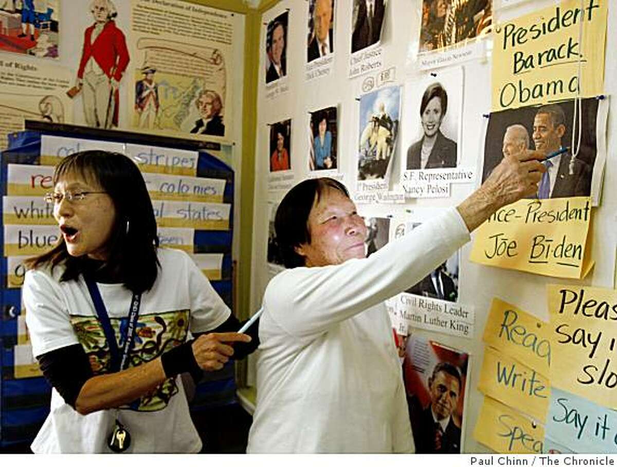 Teacher Marcia Chan (left) helped student Mei Hao Kuang identify President-elect Barack Obama in a citizenship class at CCSF's Chinatown campus in San Francisco, Calif., on Friday, Jan. 16, 2009.