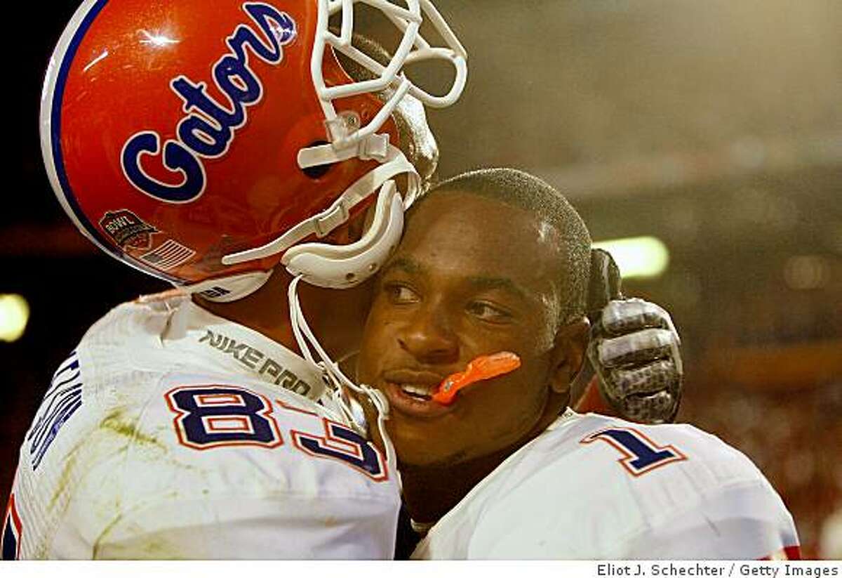 MIAMI - JANUARY 08: David Nelson #83 and Percy Harvin #1 celebrate with after defeating the Oklahoma Sooners in the FedEx BCS National Championship Game at Dolphin Stadium on January 8, 2009 in Miami, Florida. The Gators won the game by a score of 24-14. (Photo by Eliot J. Schechter/Getty Images)