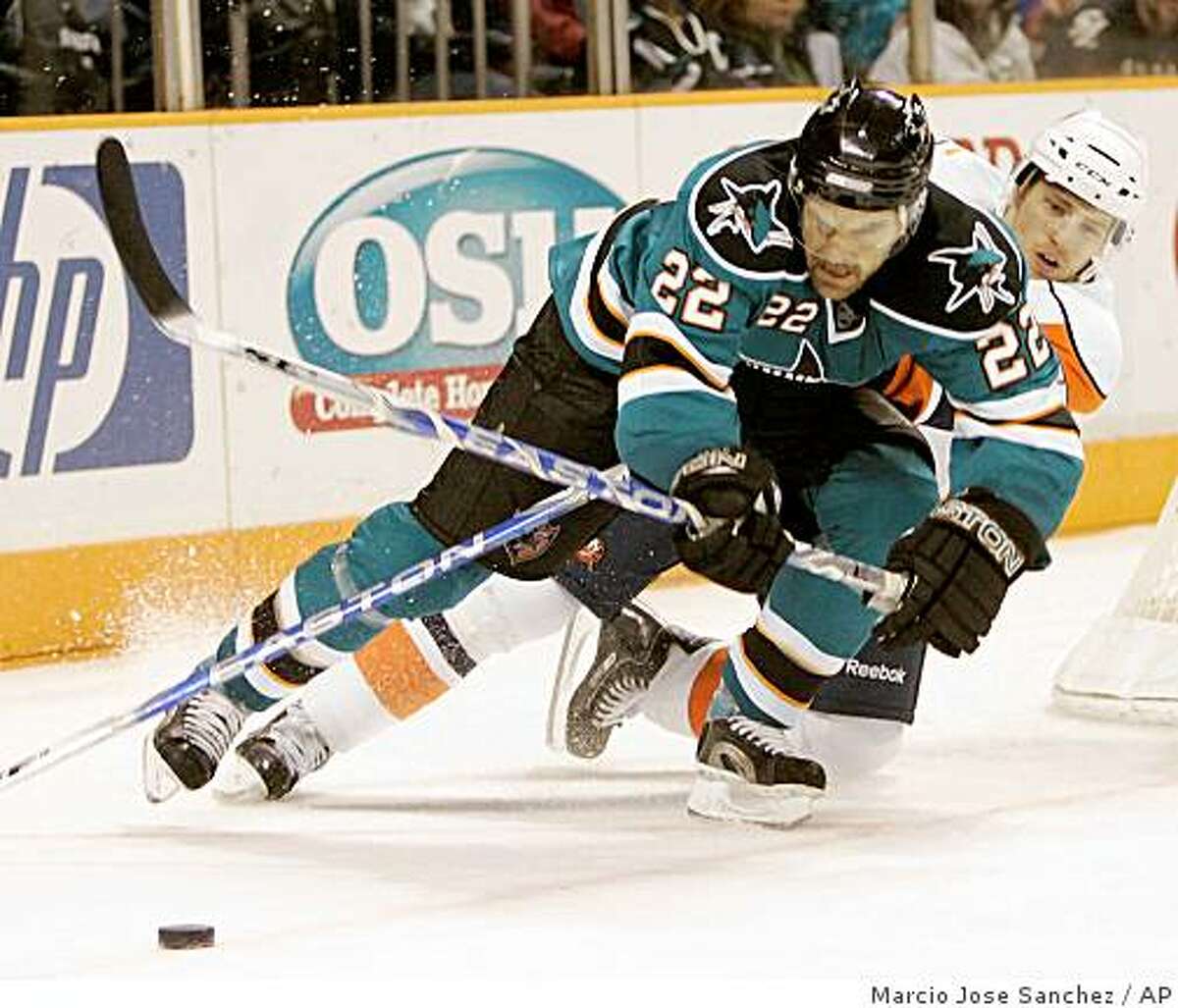 San Jose Sharks defenseman Dan Boyle goes for the puck in front of New York Islanders left wing Blake Comeau during the third period of a game in San Jose, Calif. on Saturday, Jan. 3, 2009. San Jose won 5-3.